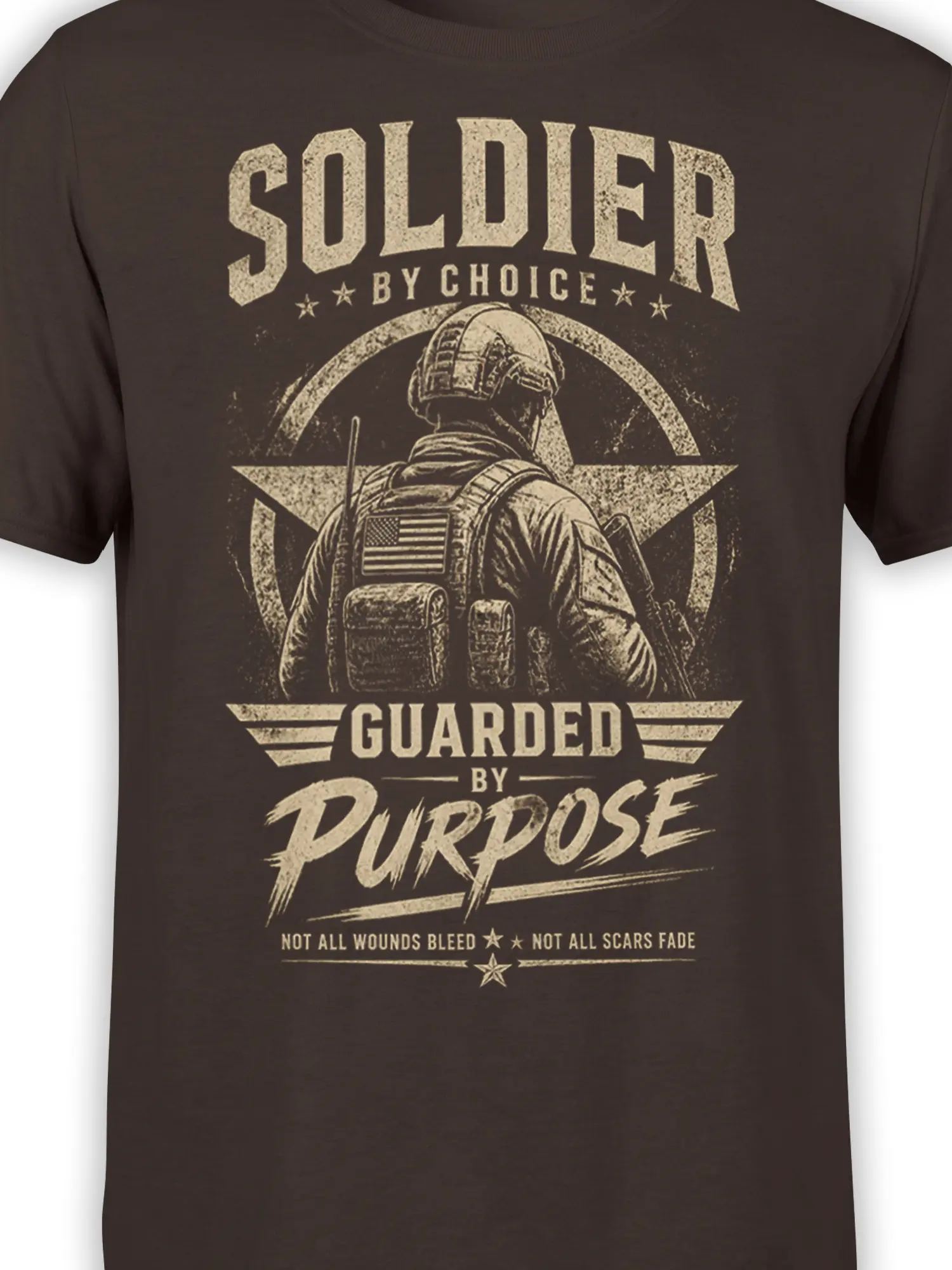 Close-up of the vintage soldier graphic, star emblem, American flag patch, and distressed cream lettering on a brown T-shirt
