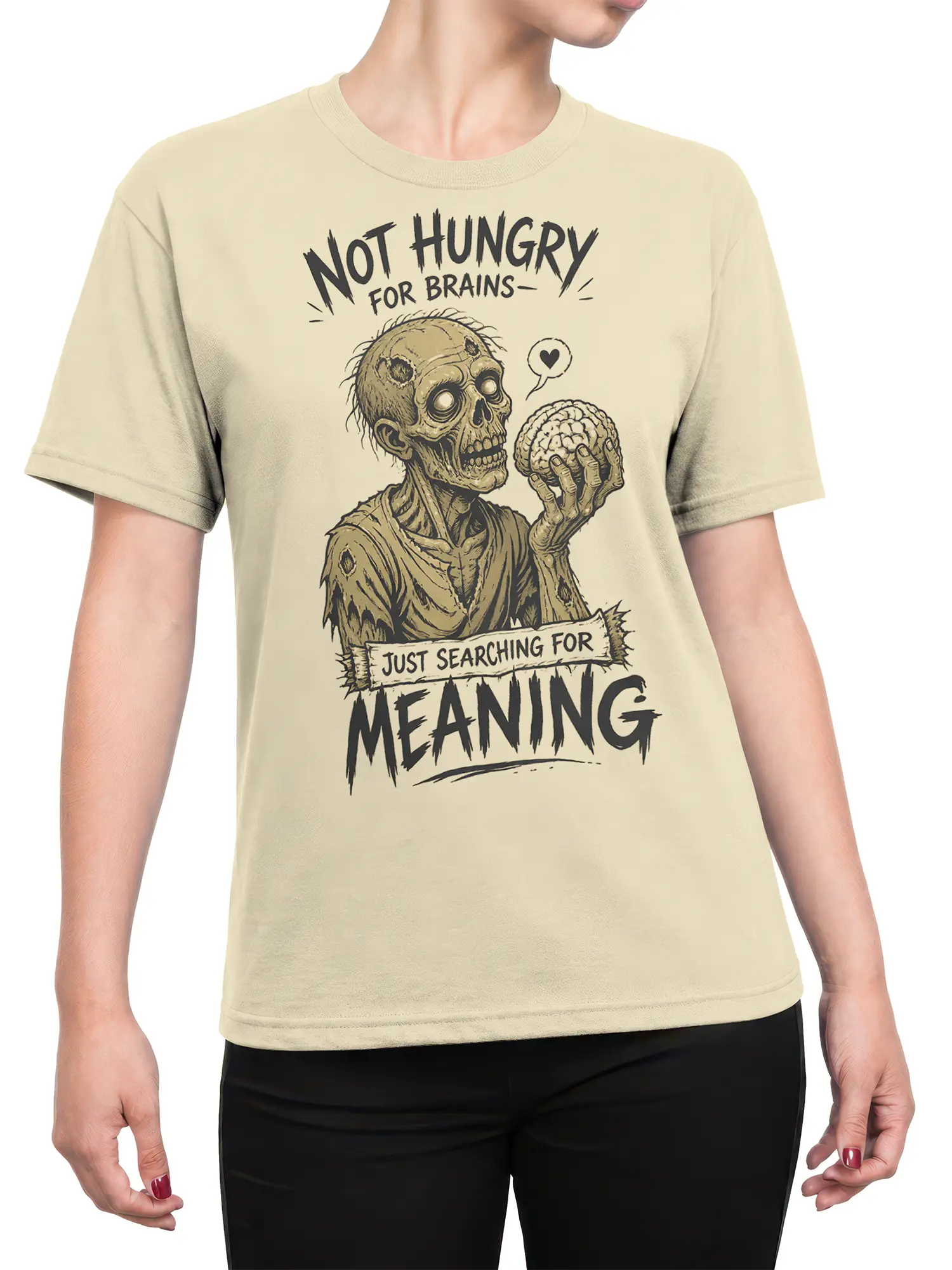 Female torso wearing a beige zombie T-shirt with existential horror artwork and bold meaning lettering