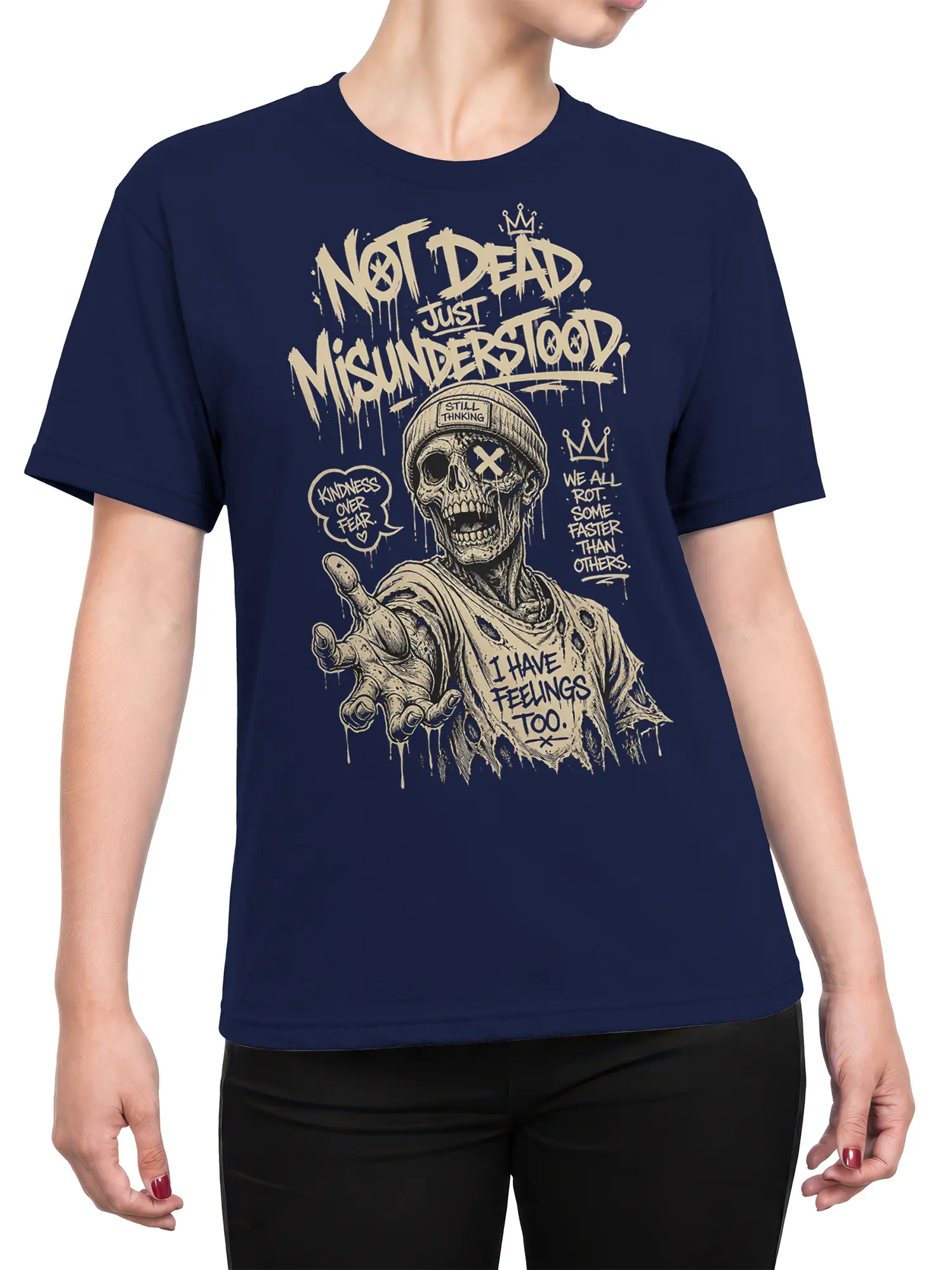 Female torso wearing a navy zombie shirt with a crowned skull and “Kindness Over Fear” graphic