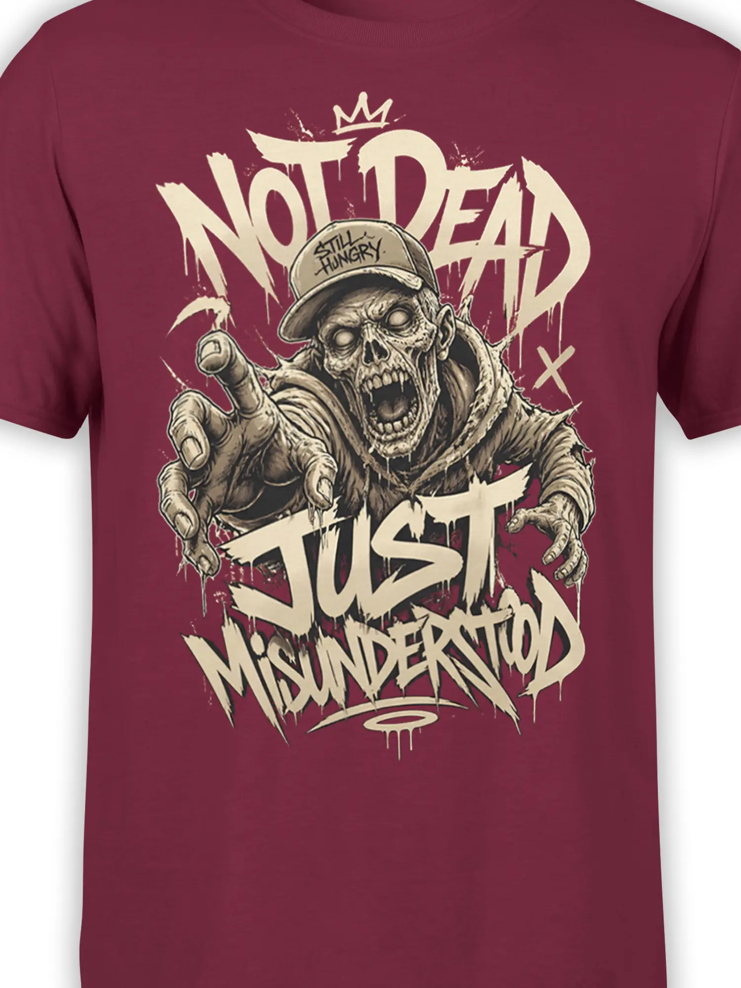 Close-up of hungry zombie face and distressed “Still Hungry” cap on a burgundy graphic T-shirt
