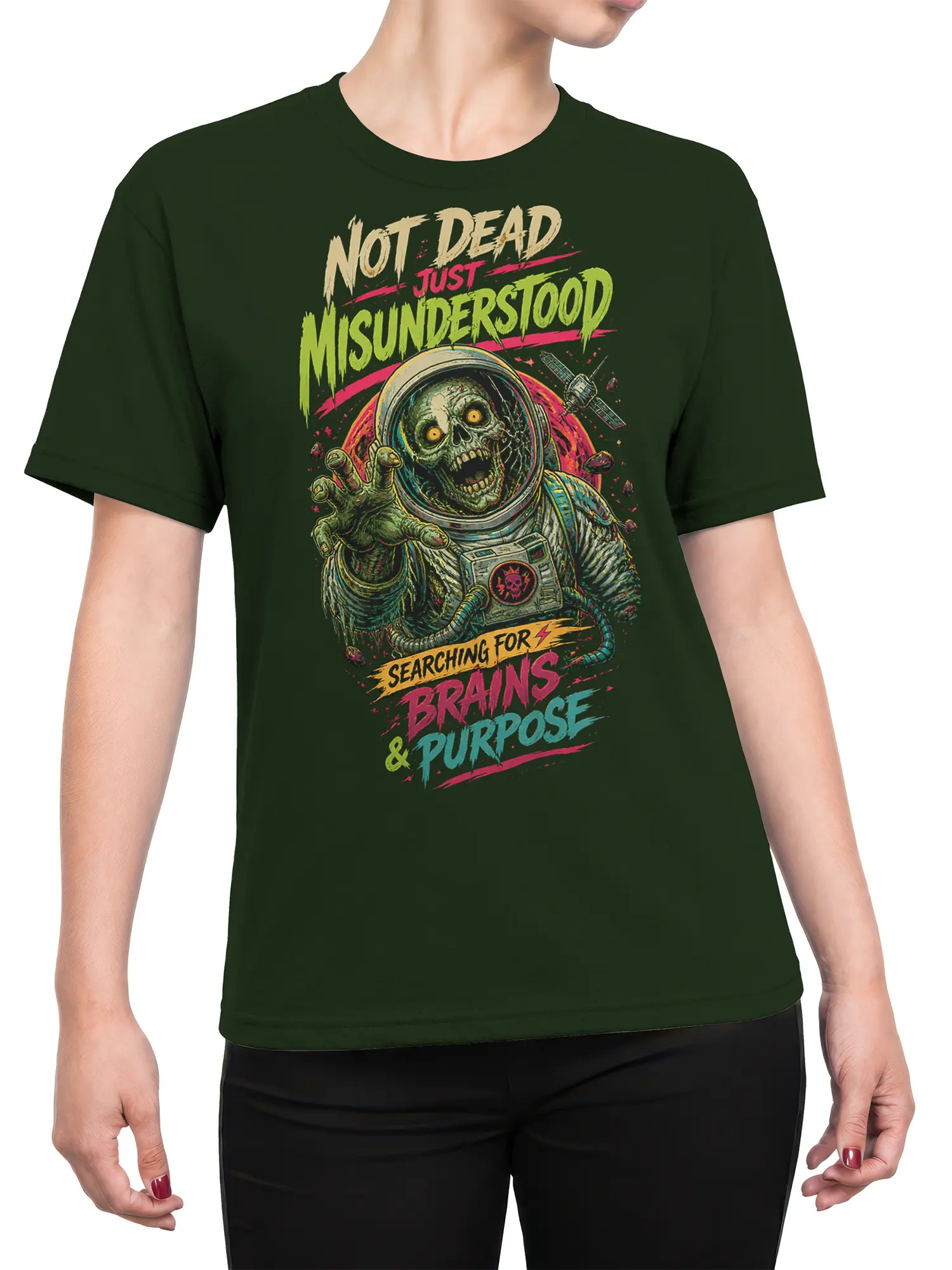 Female torso wearing a green zombie astronaut T-shirt with neon horror artwork and bold purpose-themed lettering
