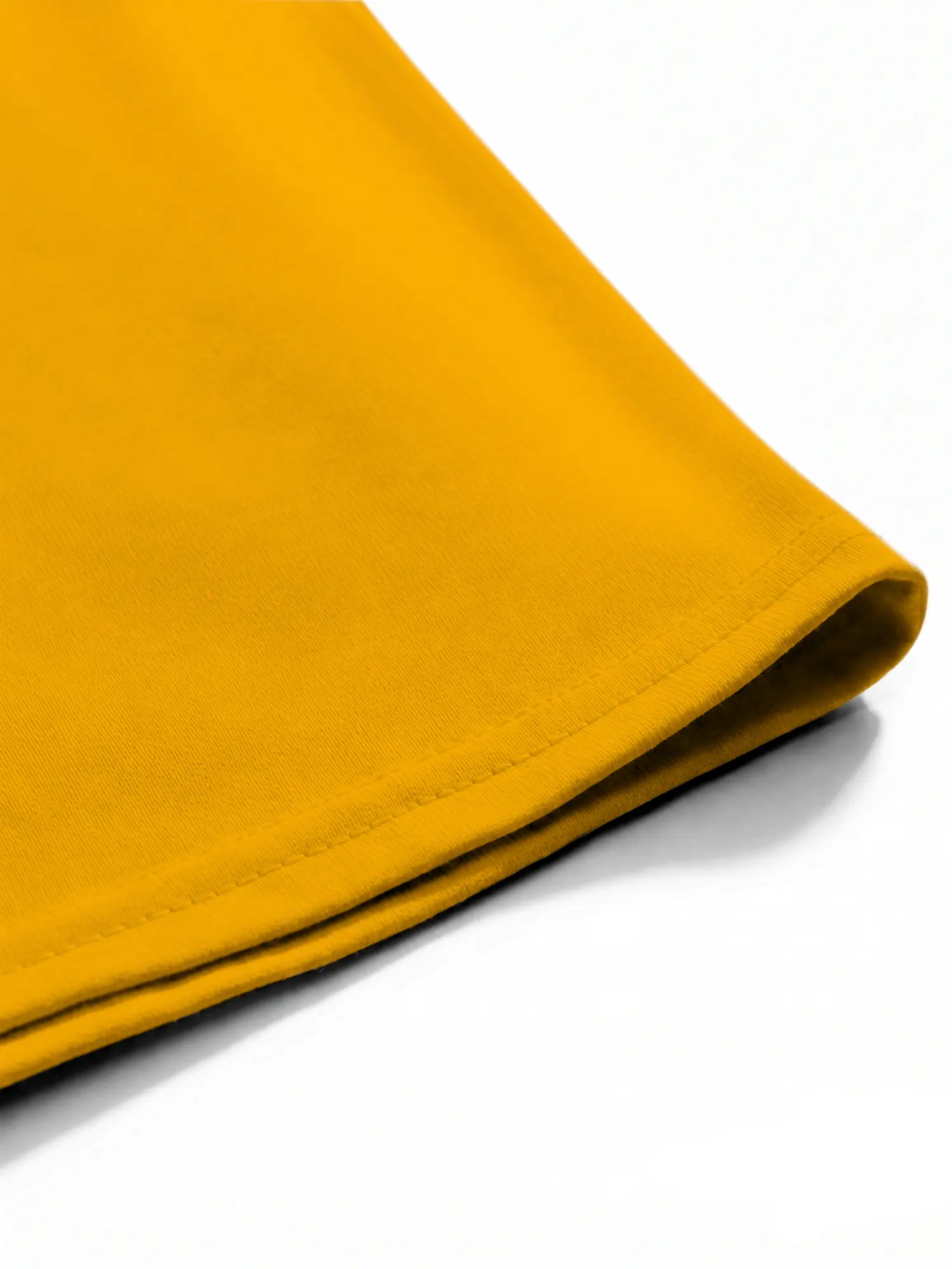 Yellow cotton T-shirt hem and stitching shown in a close-up view