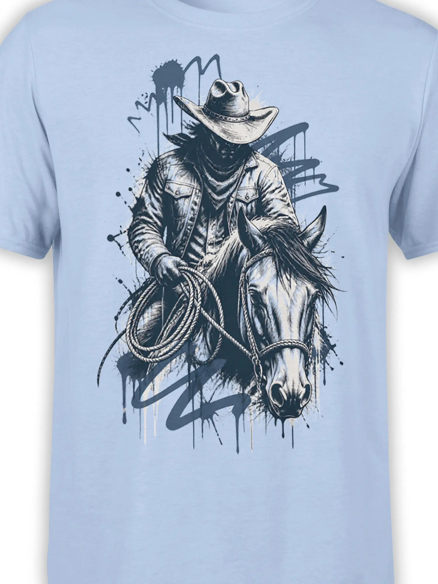 Close-up of cowboy, horse, lasso, and ink details on a light blue Western T-shirt