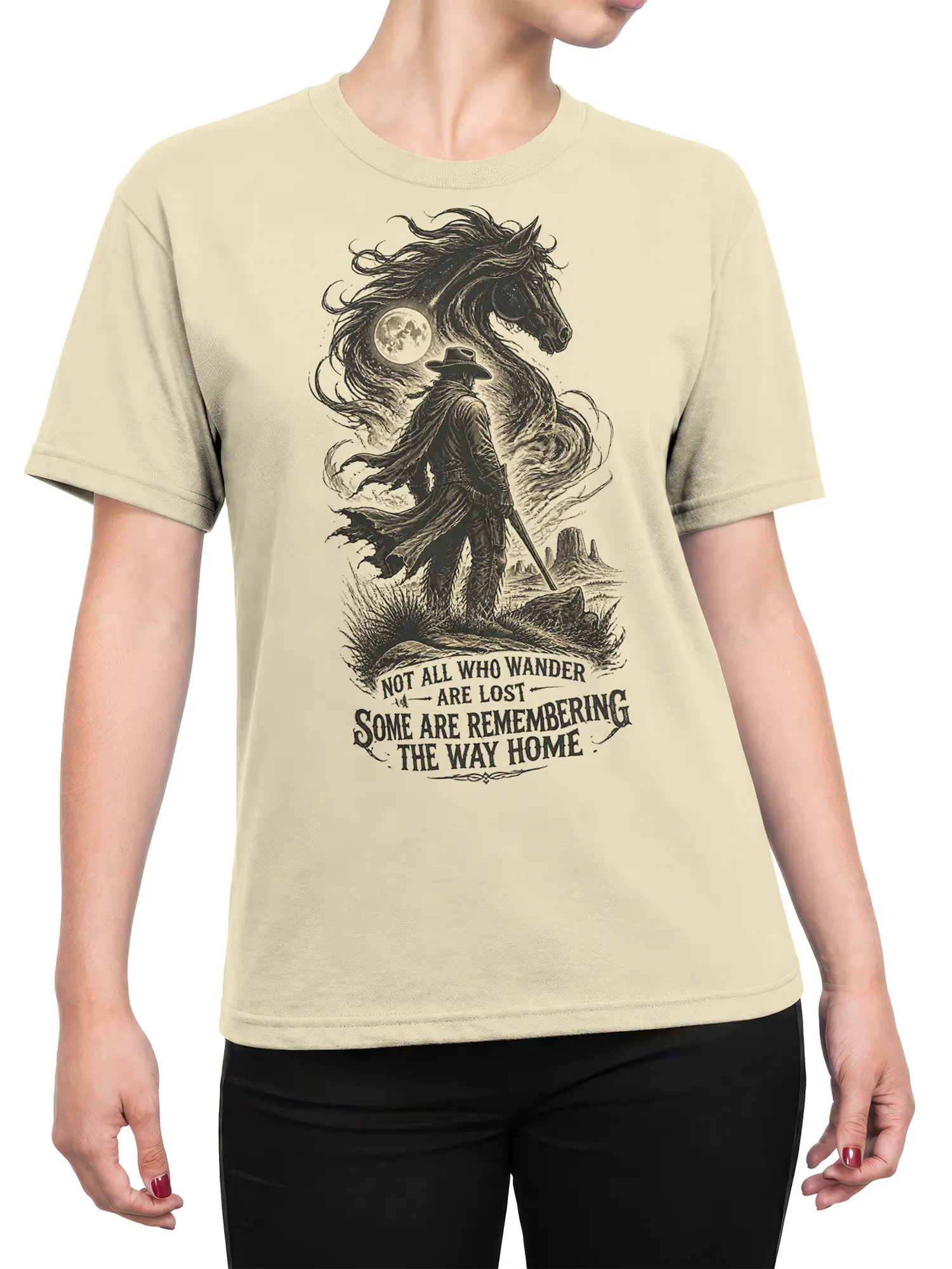 Female torso wearing a beige shirt with a vintage cowboy, horse, and moon design
