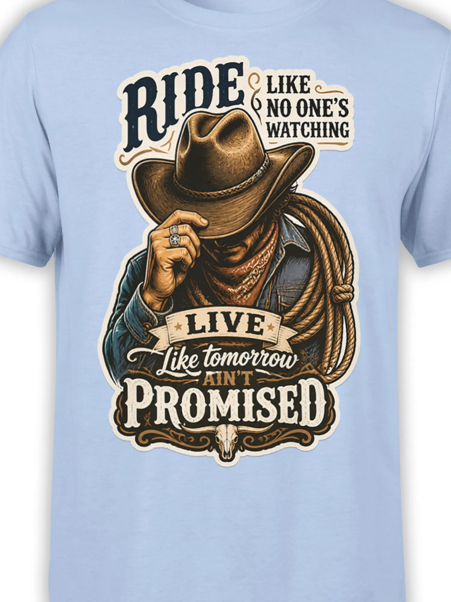 Close-up of cowboy hat, rope, skull, and vintage lettering on a light blue western T-shirt