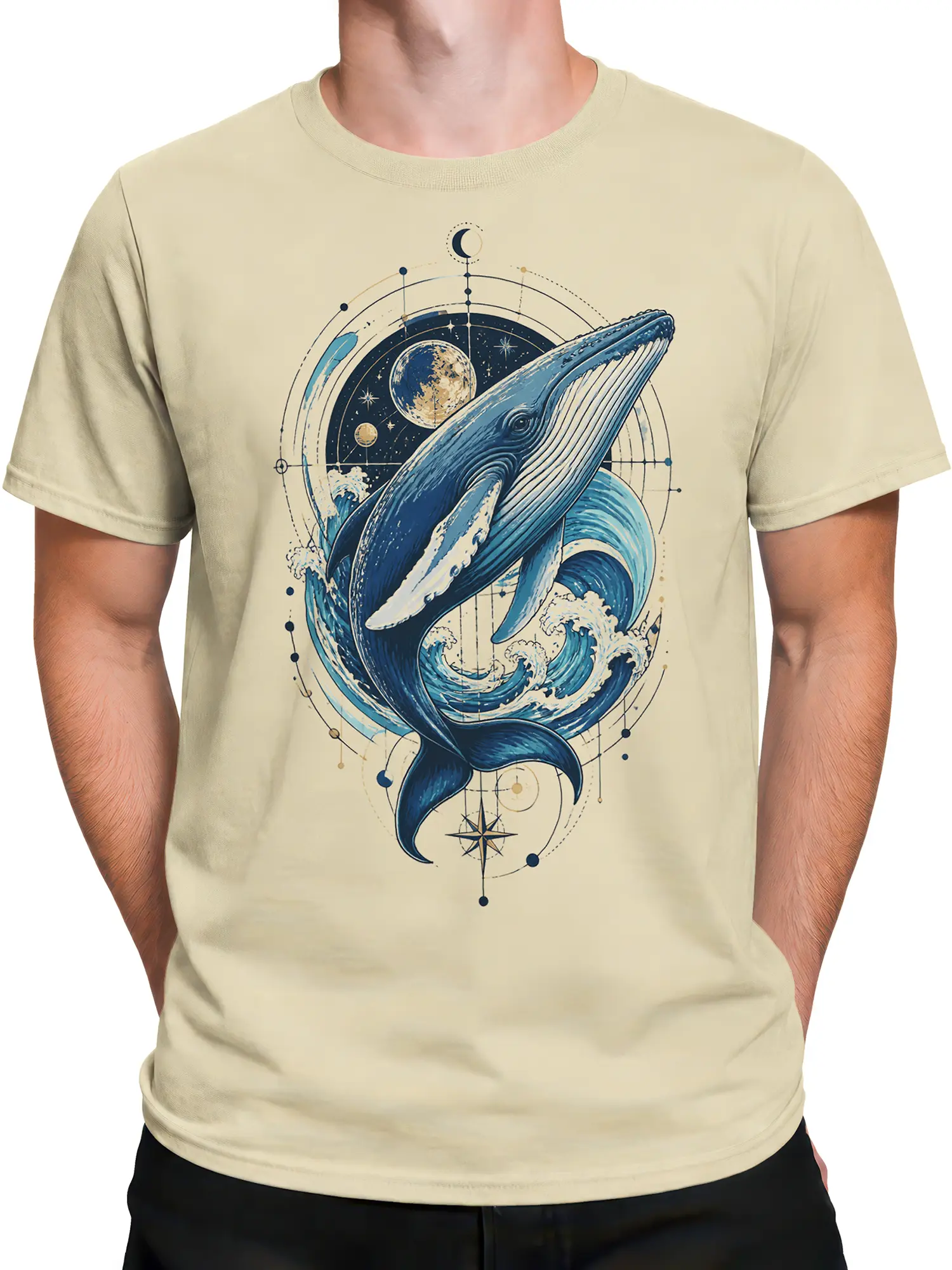 Male torso wearing a beige whale T-shirt with blue waves, moon, stars, planets, and compass artwork
