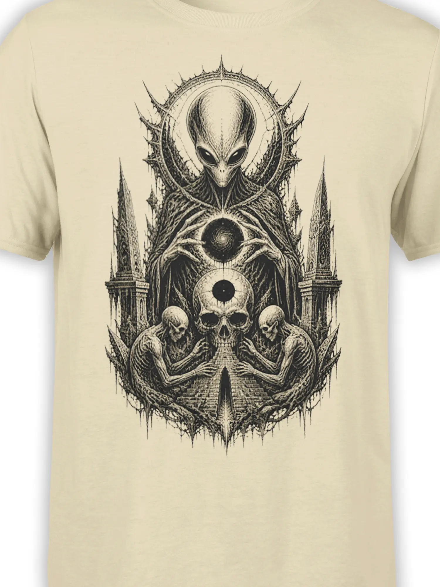 Close-up of the gothic alien and cosmic skull artwork printed in black and gray on a beige T-shirt