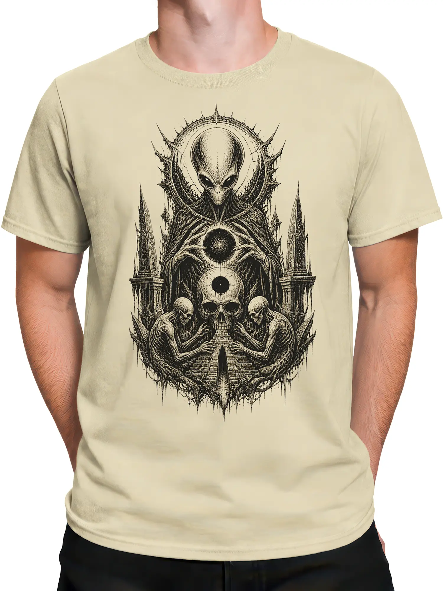 Male torso wearing a beige gothic alien T-shirt with detailed skull and skeleton artwork