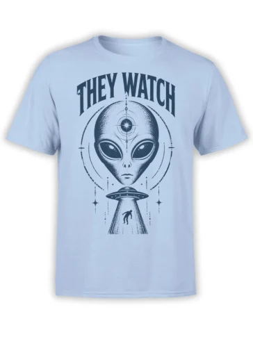 Light blue alien abduction T-shirt with a watchful extraterrestrial, flying saucer beam, stars, and “THEY WATCH” text