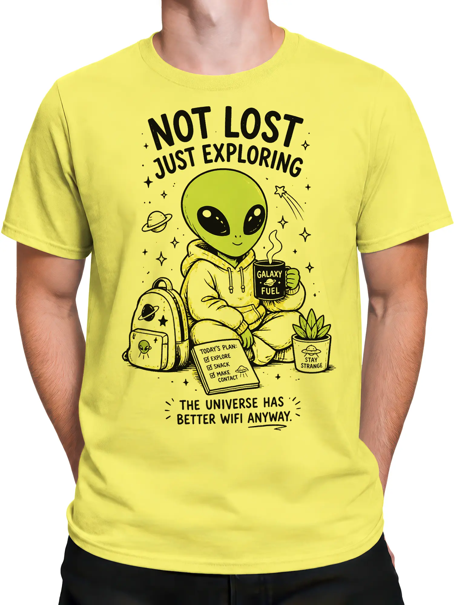 Male torso wearing a yellow alien explorer T-shirt with a backpack, planets, cosmic coffee, and space-themed text