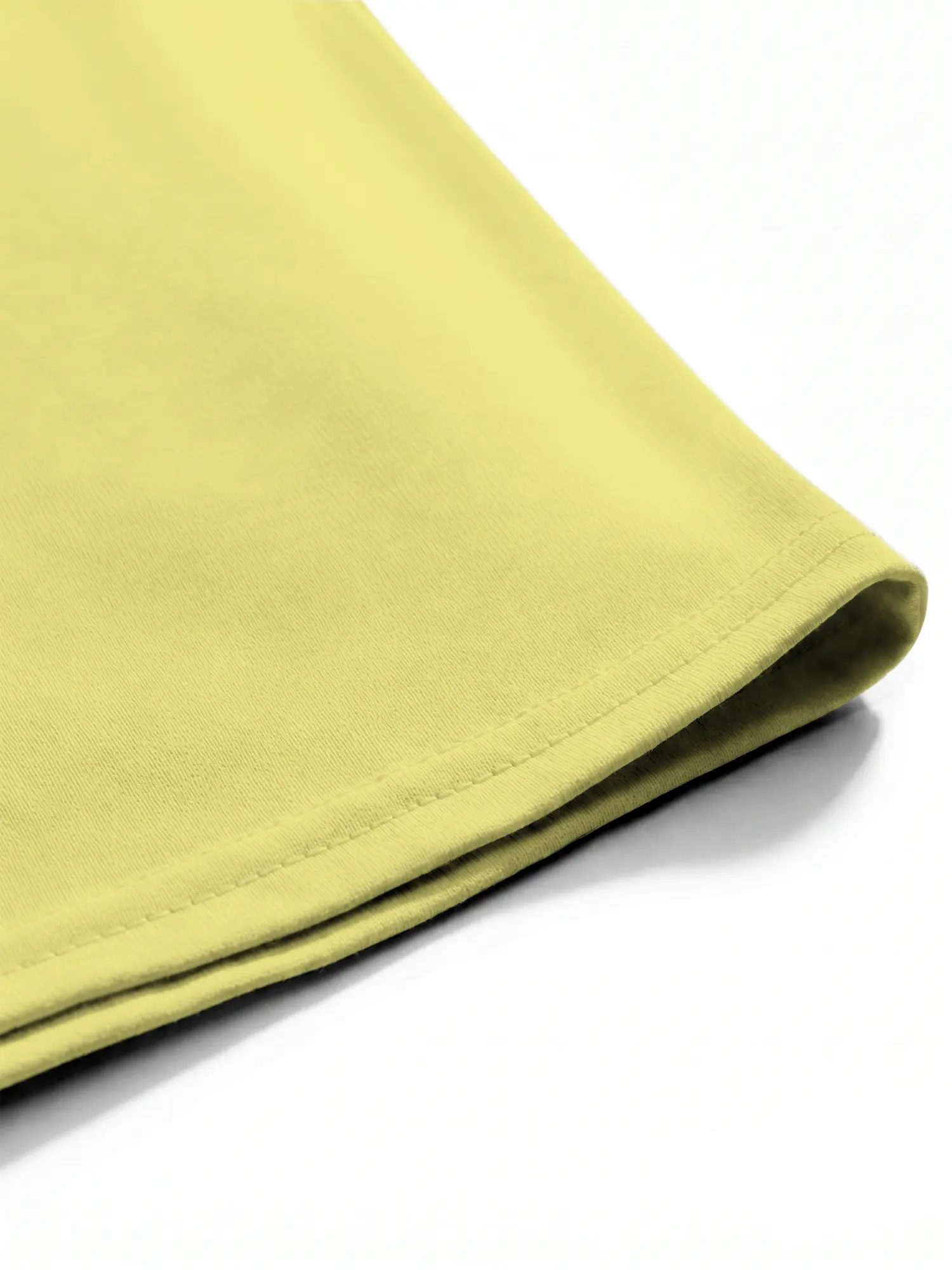 Yellow cotton T-shirt hem and stitching shown in a close-up product detail