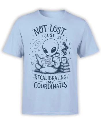 Light blue alien T-shirt with a cosmic reader, coffee cup, books, planets, and recalibrating coordinates text