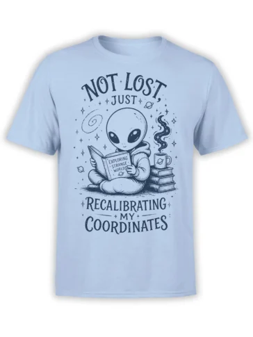 Light blue alien T-shirt with a cosmic reader, coffee cup, books, planets, and recalibrating coordinates text