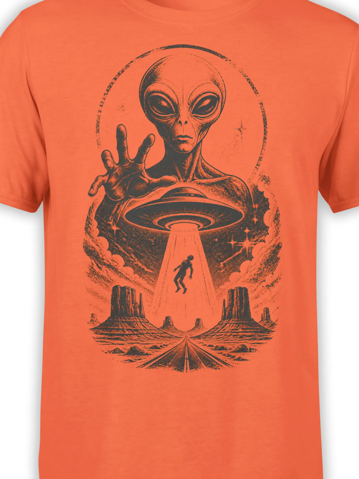 Close-up of the vintage alien and flying saucer abduction design printed on an orange T-shirt