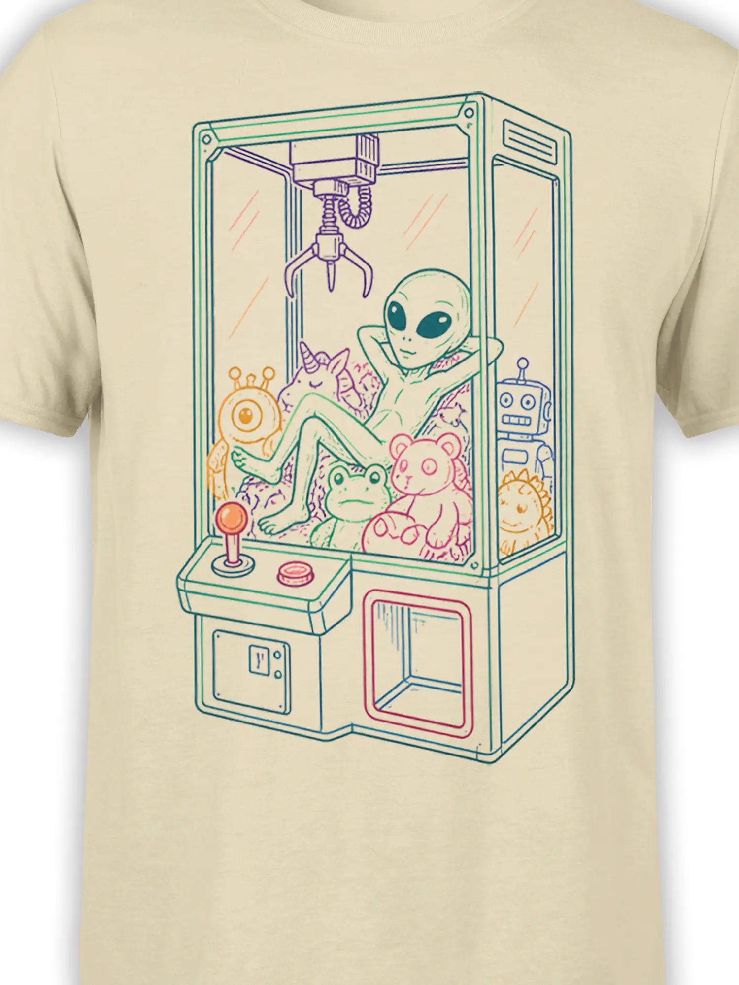 Close-up of the alien claw machine artwork on a beige T-shirt with pastel green, pink, purple, orange, and teal details