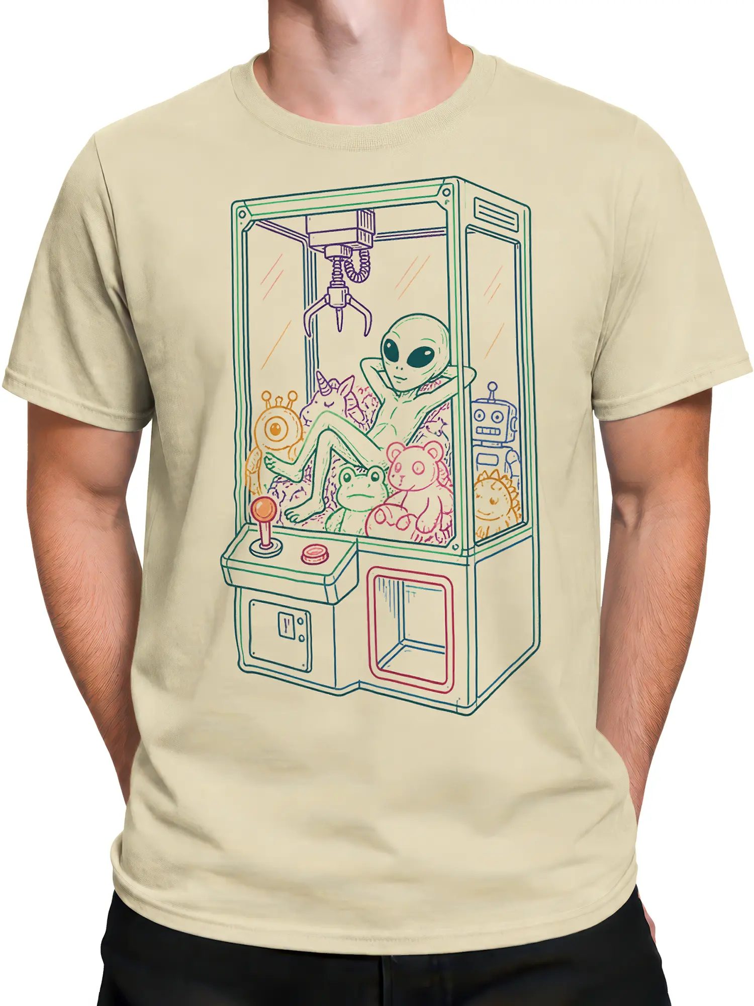 Male torso wearing a beige alien claw machine T-shirt with a retro pastel arcade design