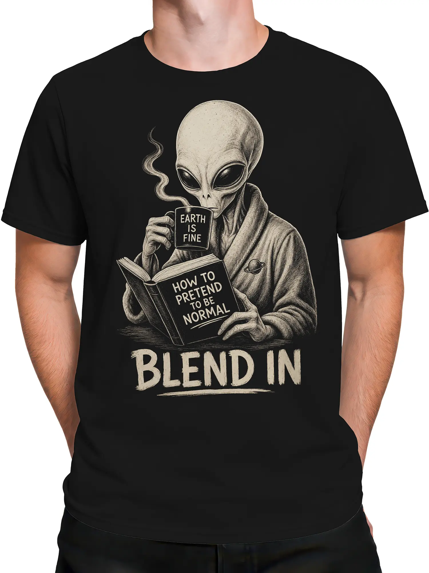 Male torso wearing a black alien T-shirt with vintage space artwork and “BLEND IN” lettering