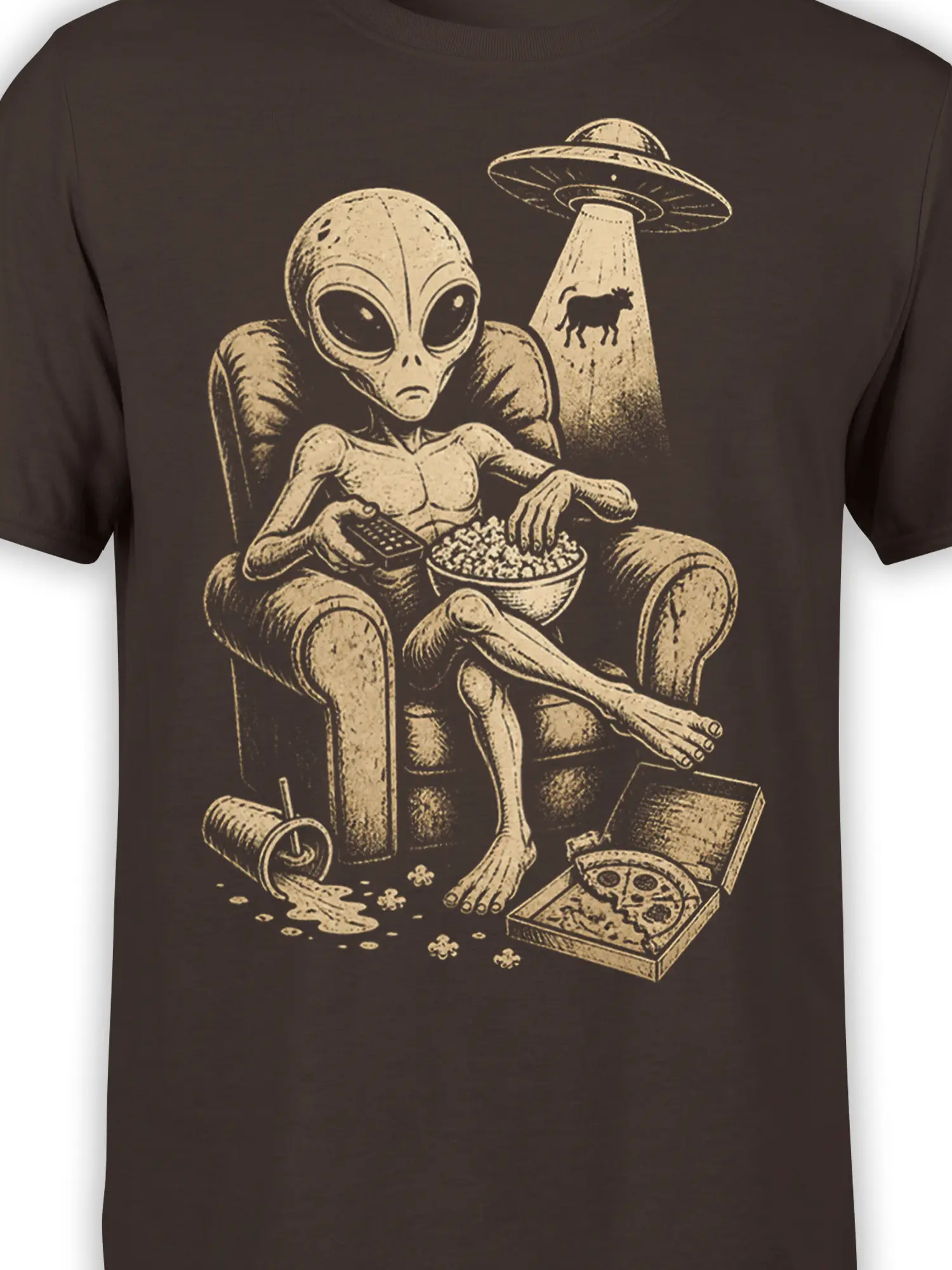 Close-up of brown alien graphic tee showing the lounging extraterrestrial, popcorn bowl, remote control, pizza, and UFO