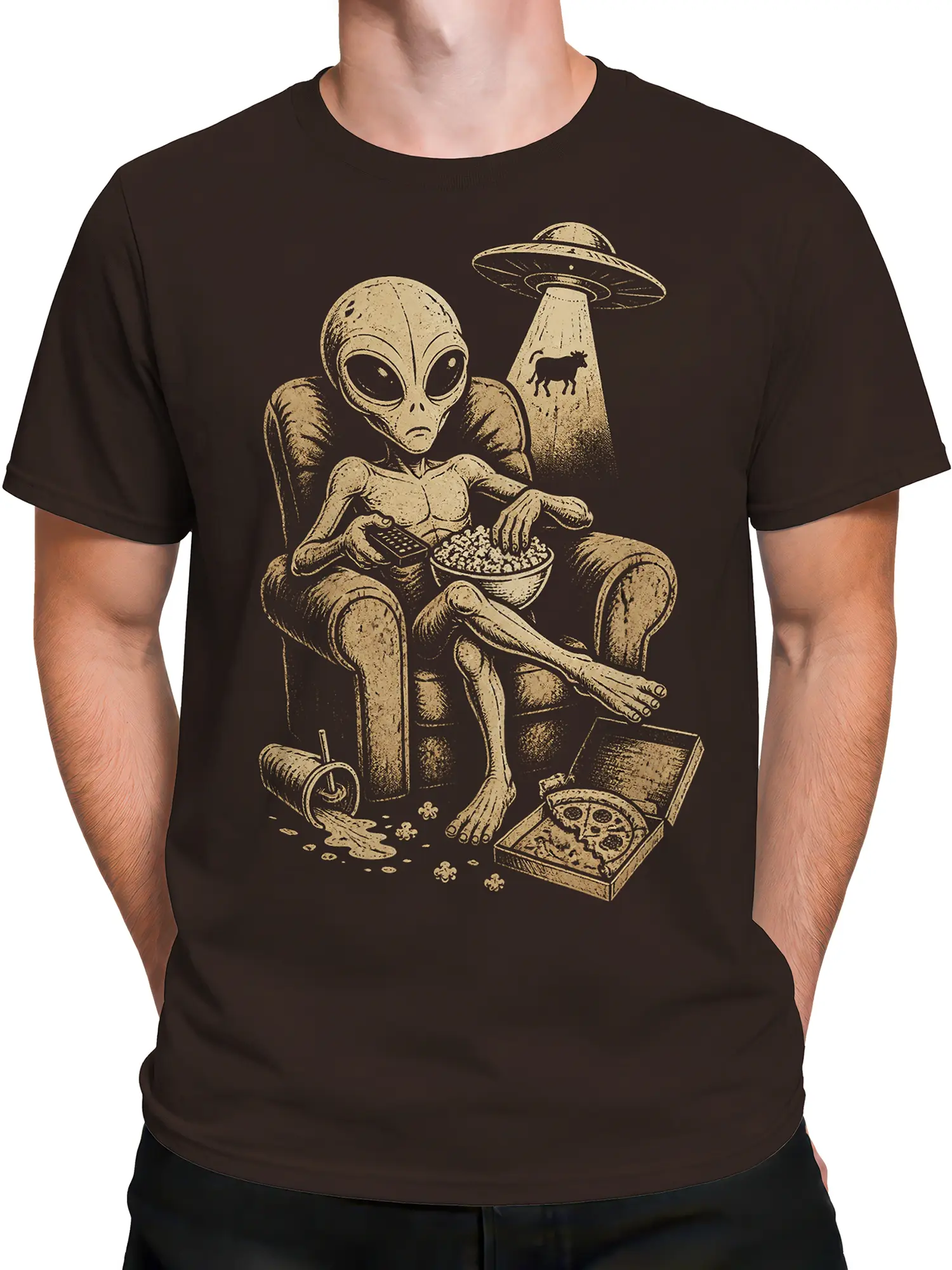 Male torso wearing a brown alien T-shirt with a retro UFO scene, popcorn bowl, pizza box, and lounging extraterrestrial