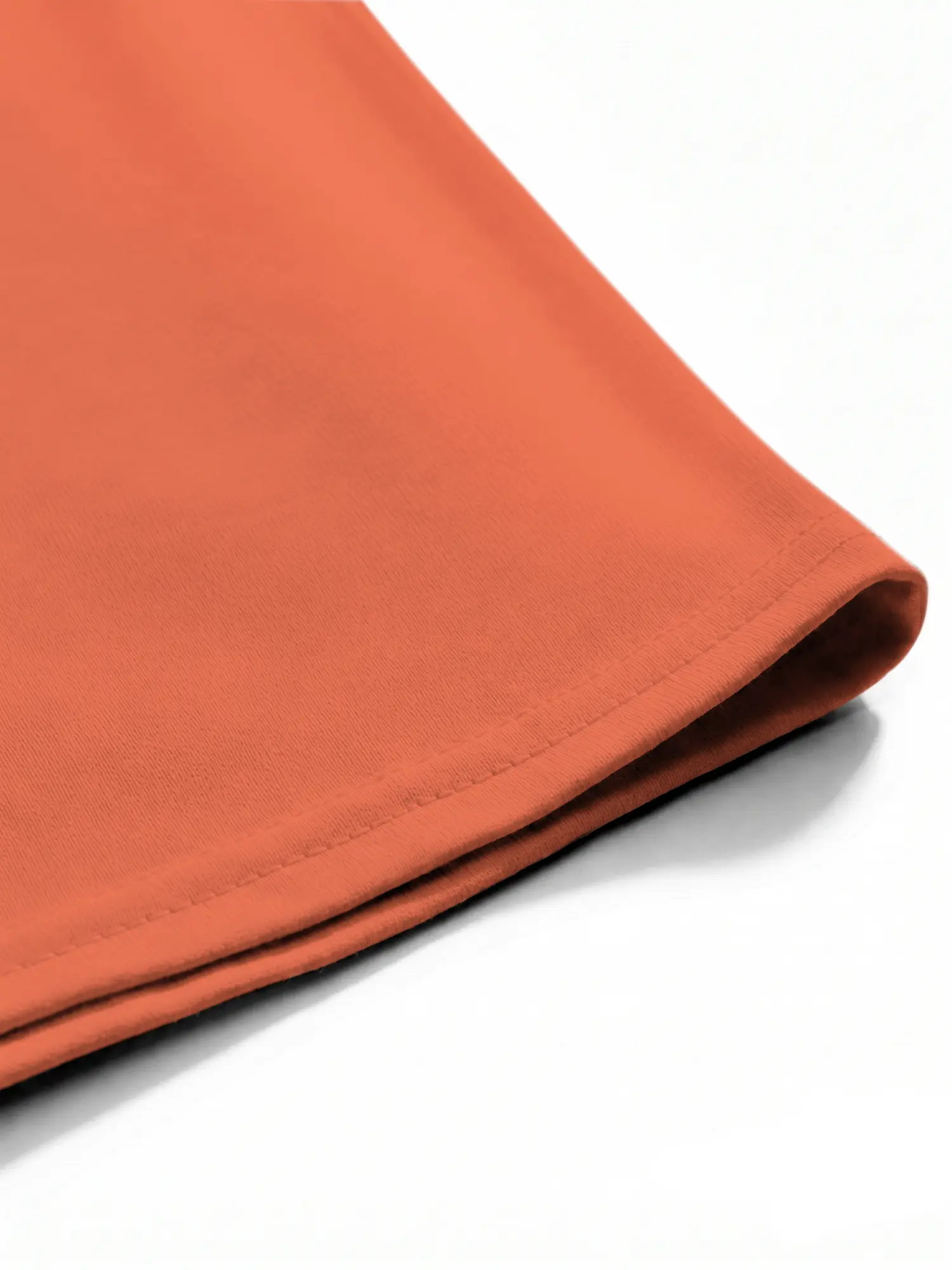 Orange T-shirt hem and stitching detail shown in a close-up view