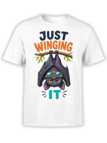 White bat T-shirt with an upside-down goggle-wearing bat, leafy branch, and “Just Winging It” lettering