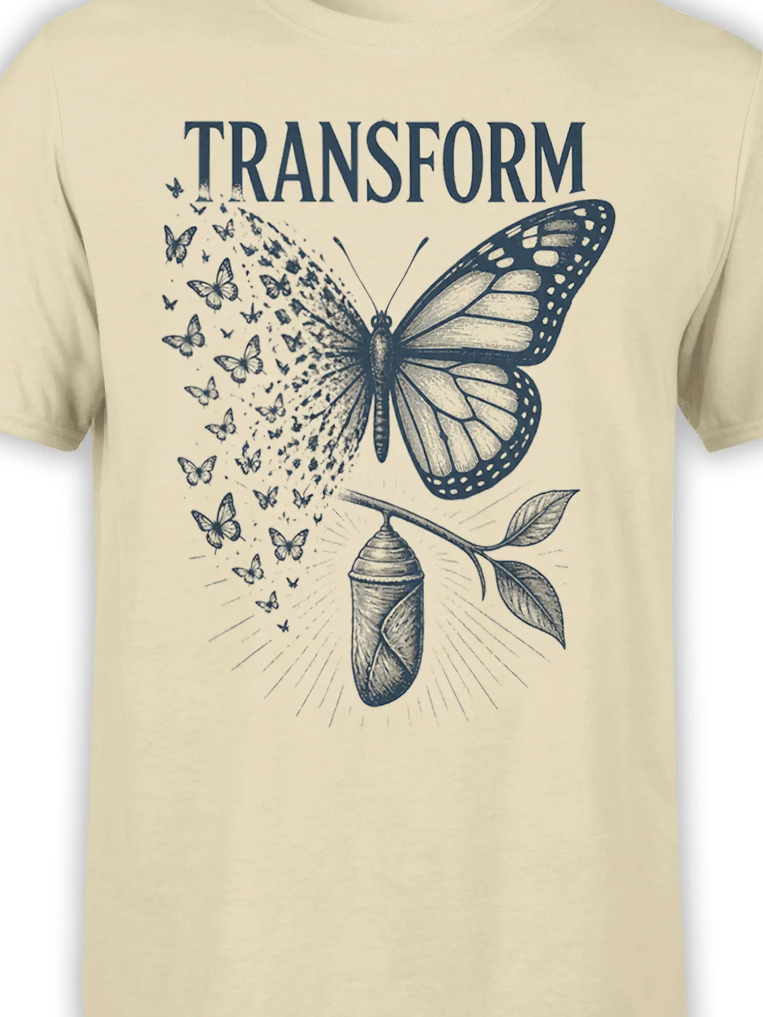 Close-up of the deep blue butterfly, chrysalis, leafy branch, and TRANSFORM artwork printed on a beige T-shirt