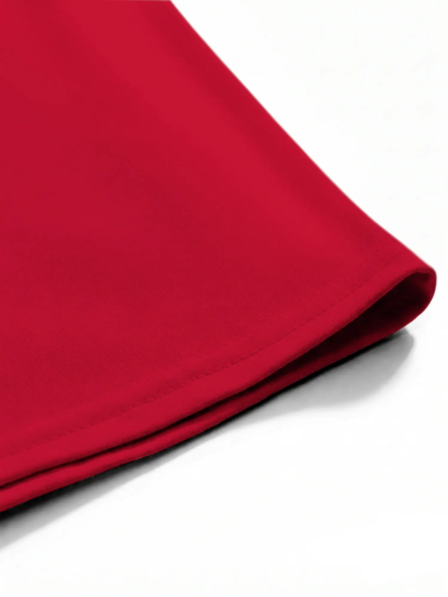 Red T-shirt hem and stitching detail close-up