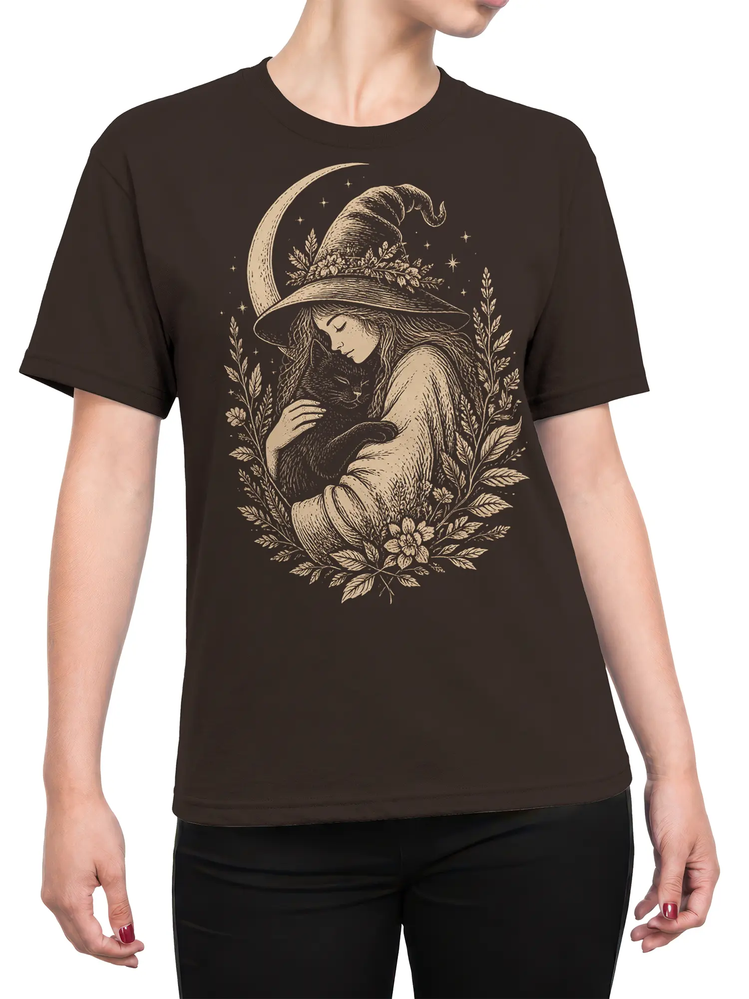 Female torso wearing a dark brown T-shirt with a moonlit witch and black cat design