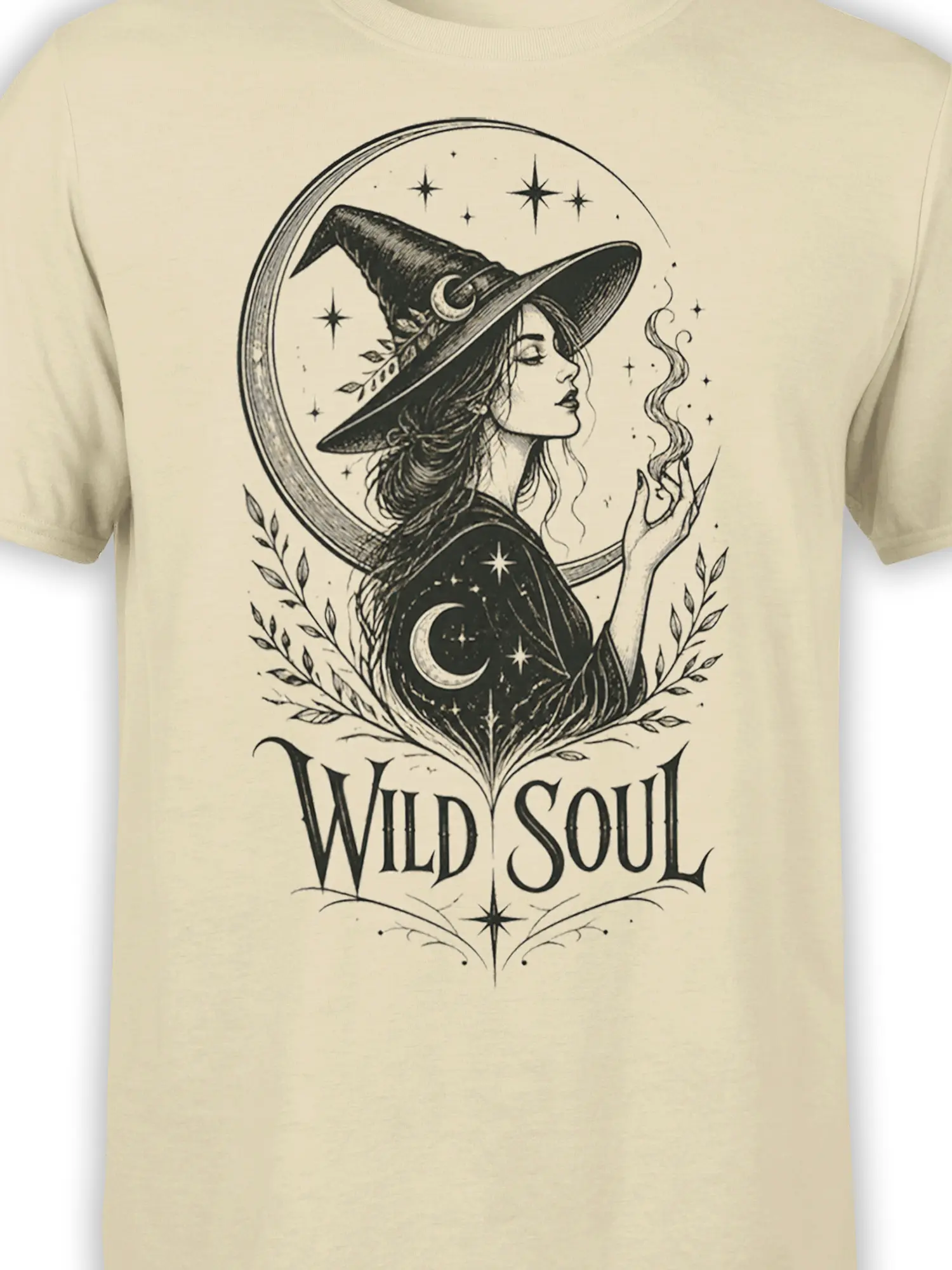 Close-up of beige witch T-shirt design with pointed hat, crescent moon, stars, and Wild Soul lettering