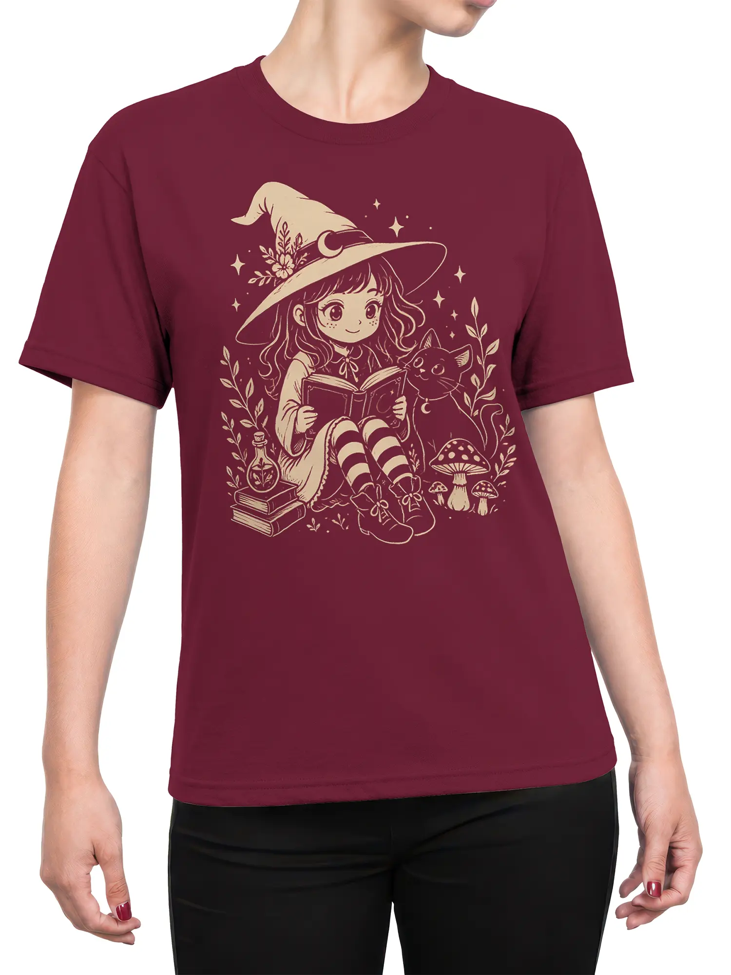 Female torso wearing a burgundy T-shirt with a witch, reading cat, books, stars, and mushrooms