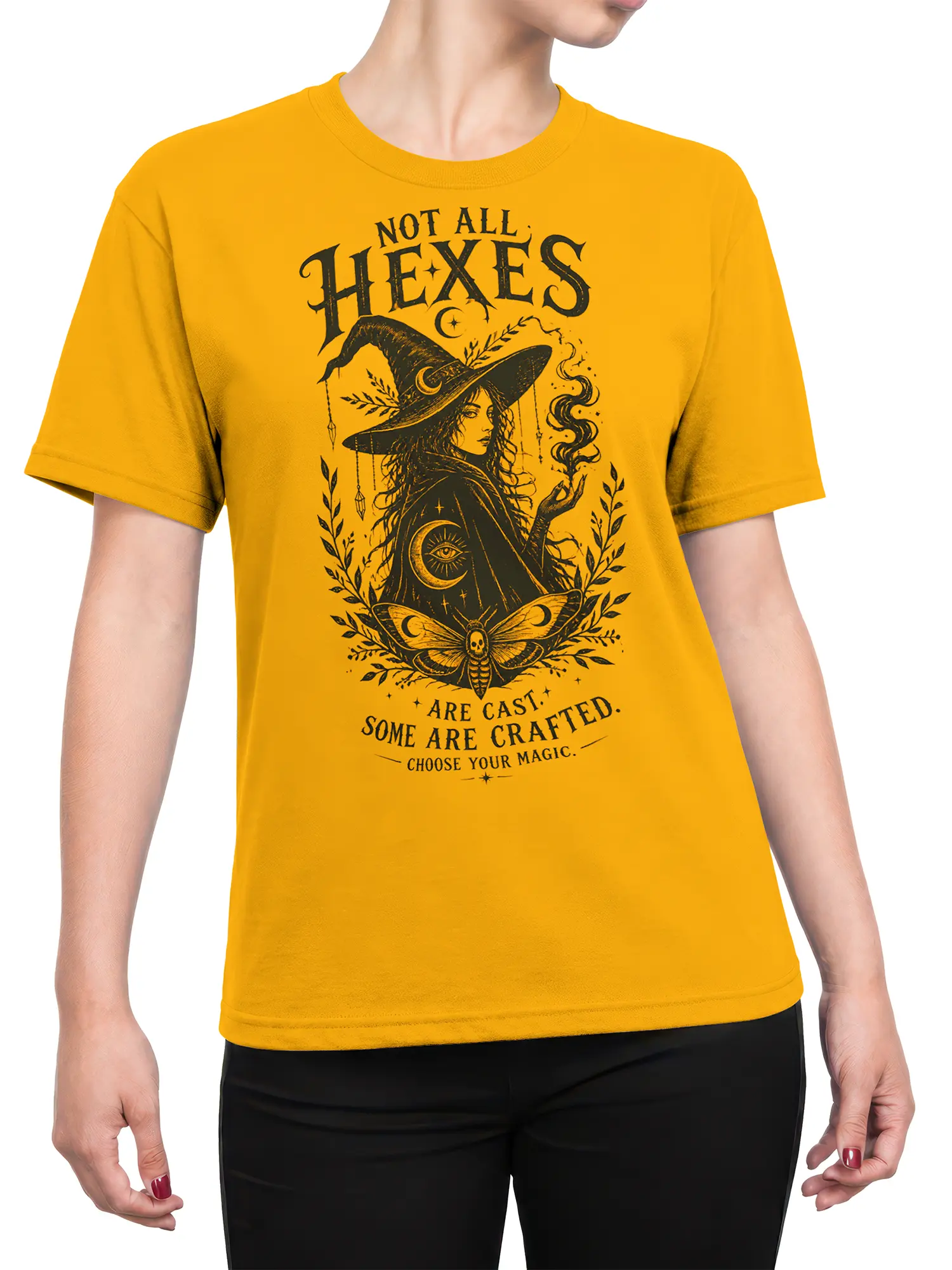 Female torso wearing a yellow witch t-shirt with mystical moon, moth, and crafted magic artwork