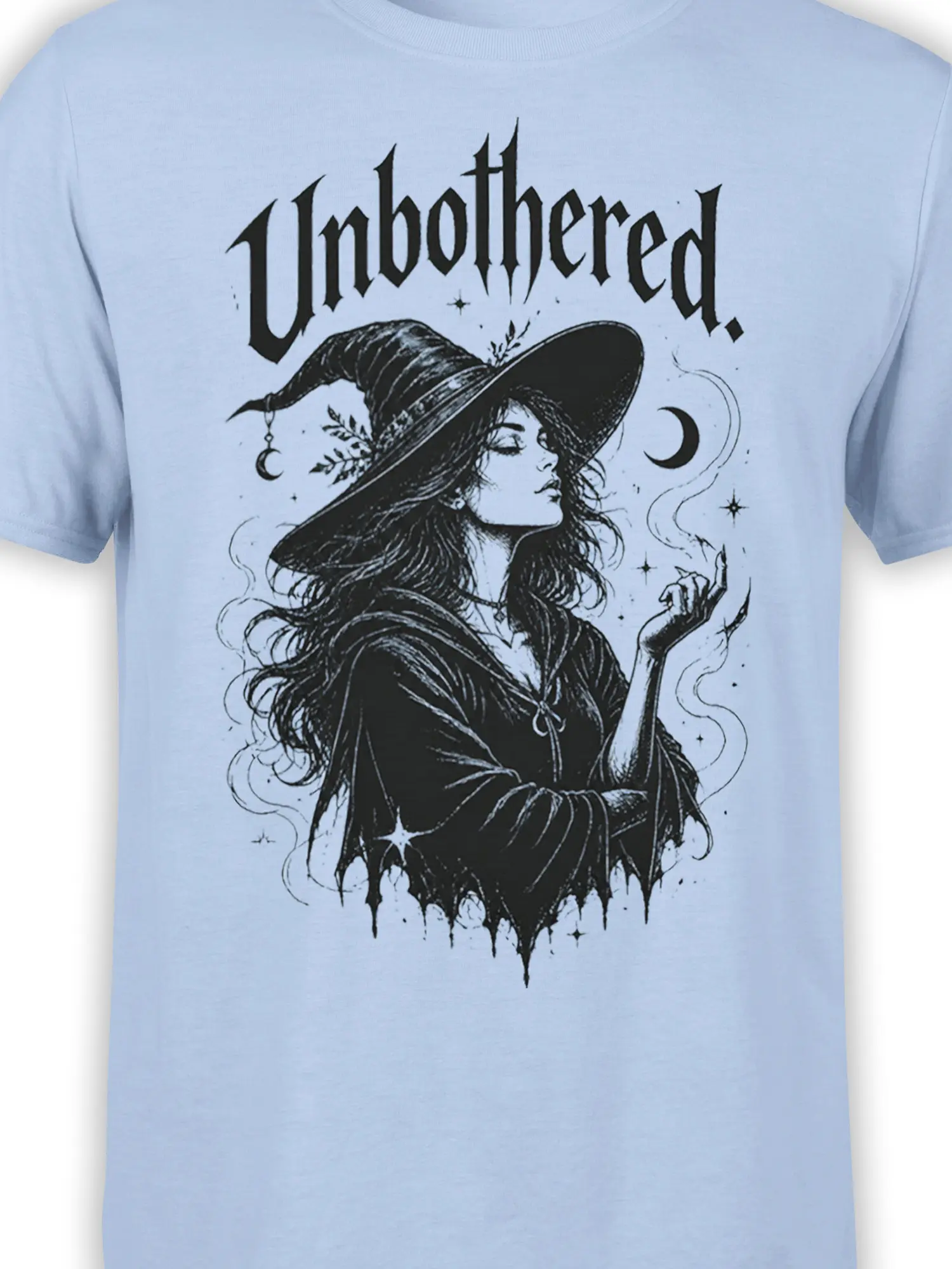 Close-up of unbothered witch artwork with crescent moon and stars on a light blue shirt