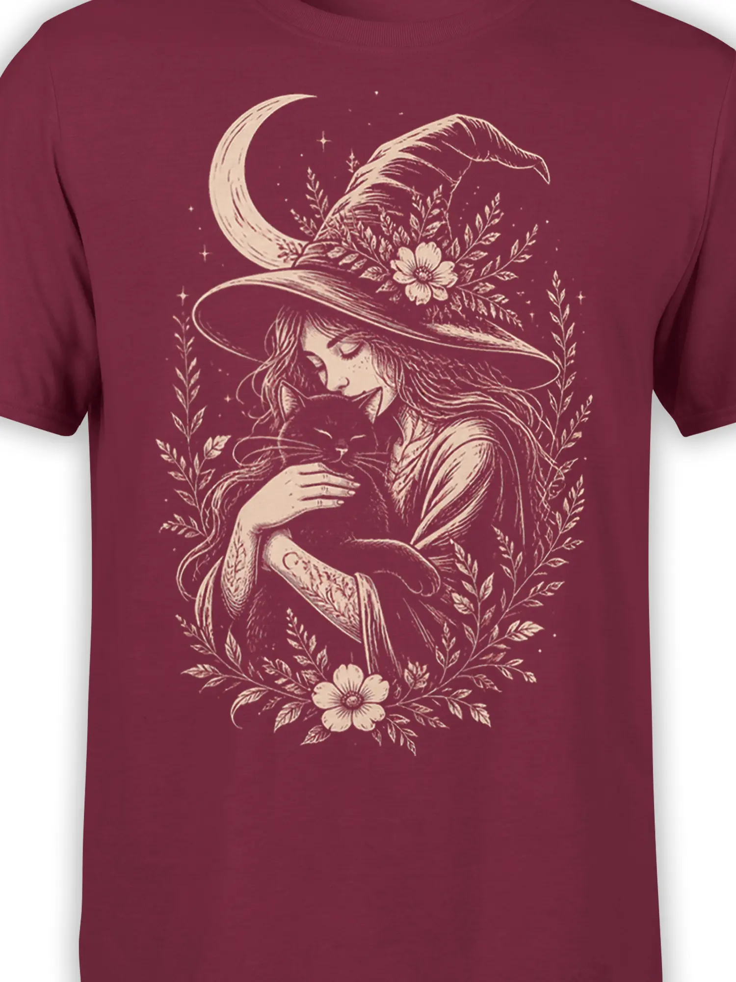 Close-up of the witch and black cat design with crescent moon, stars, and botanical details on burgundy fabric