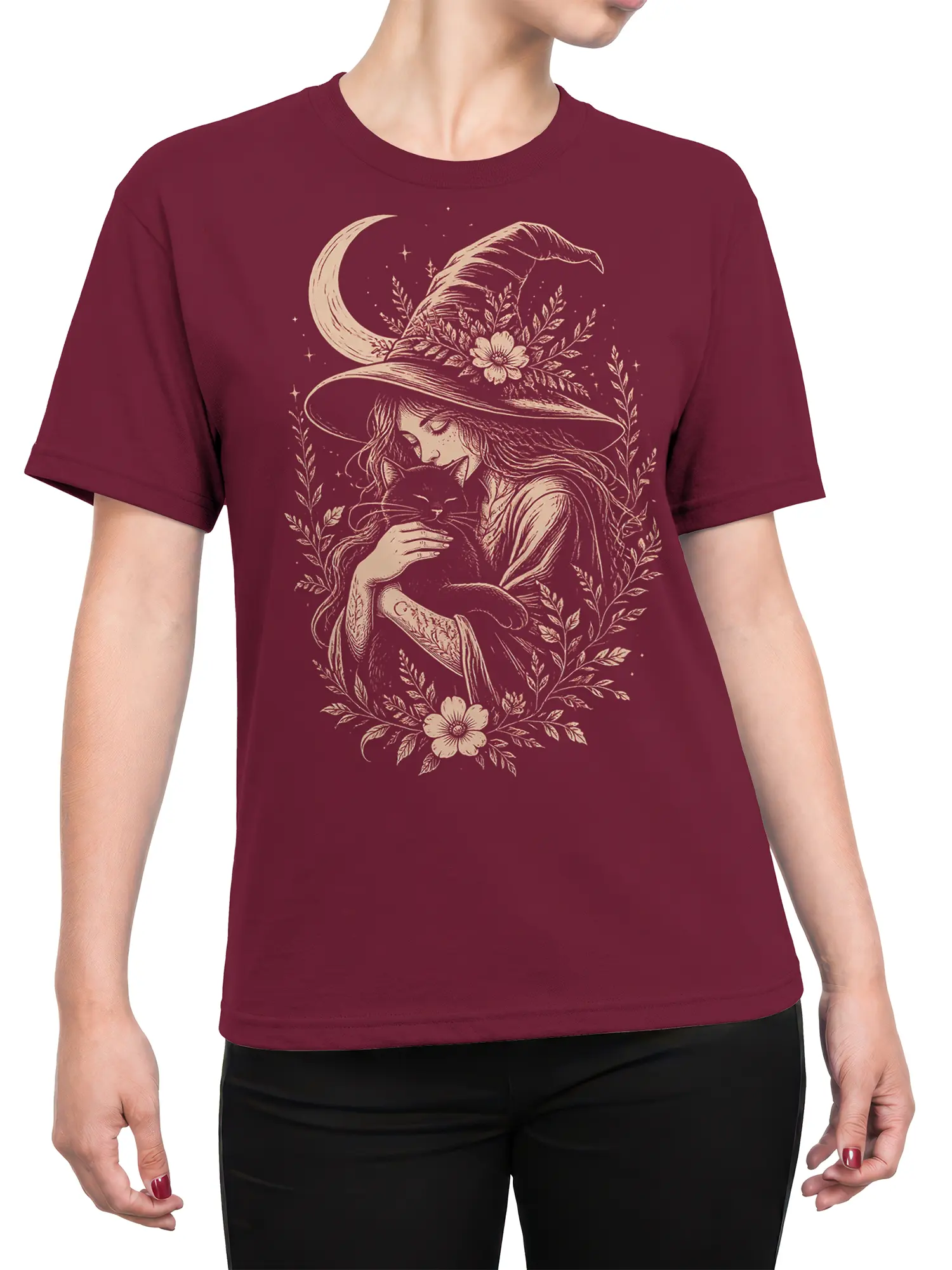 Female torso wearing a burgundy witch t-shirt with a black cat, moon, stars, and vintage botanical artwork
