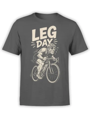 Gray cycling T-shirt with muscular cyclist riding a road bike beneath bold cream LEG DAY lettering