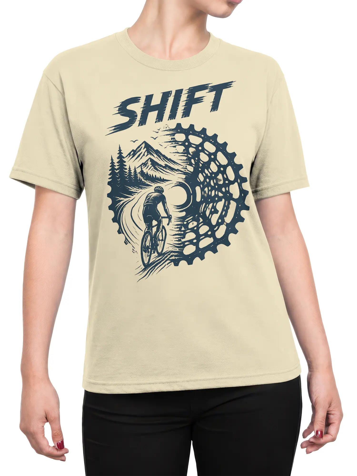 Female torso wearing a beige cycling T-shirt with cyclist, mountain, pine tree, and gear artwork