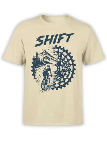 Beige cycling T-shirt with dark blue cyclist, mountain trail, pine trees, gear wheel, and SHFT lettering
