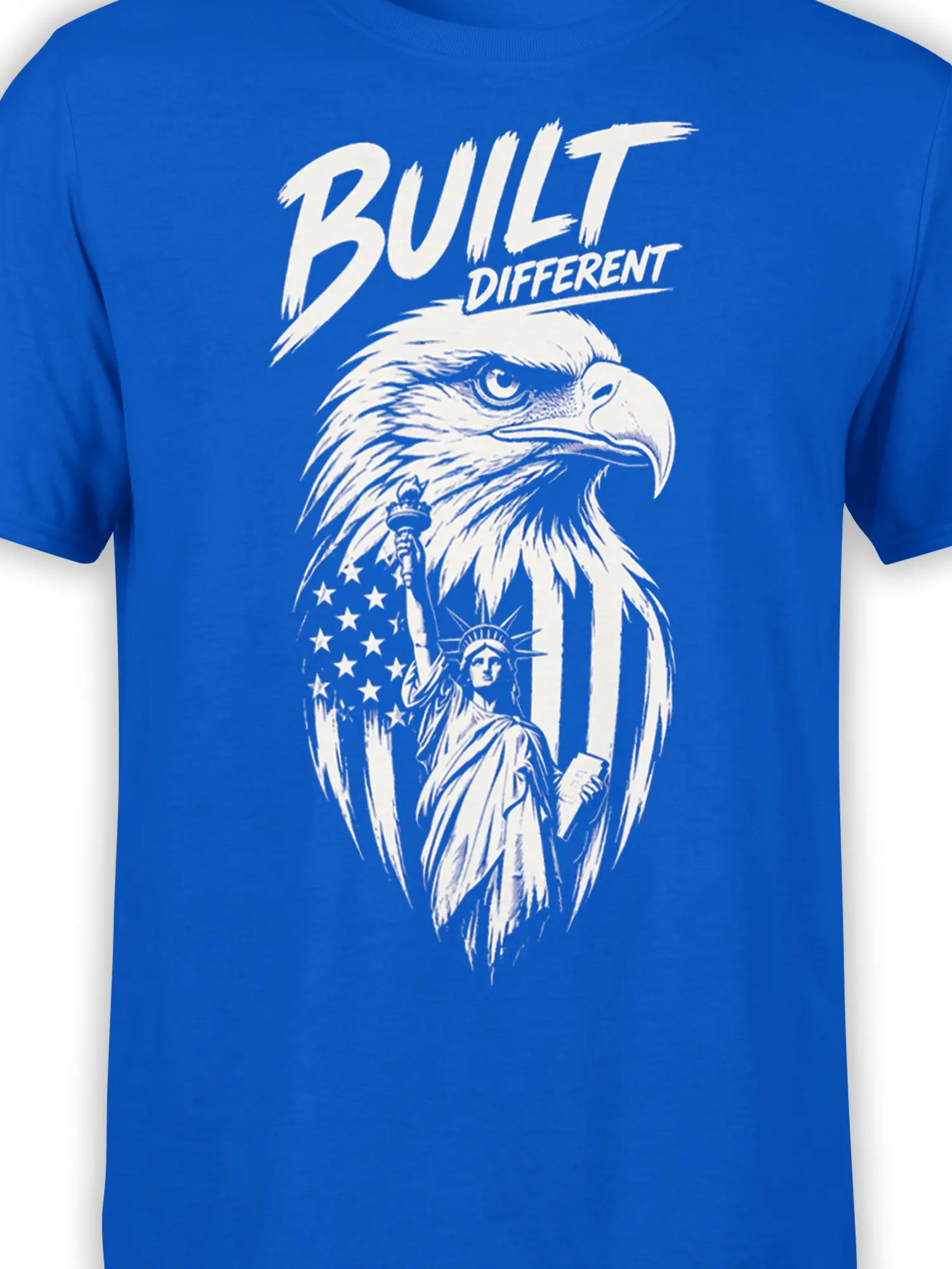 Close-up of the white eagle graphic, flag stars, liberty figure, and Built Different lettering on blue fabric