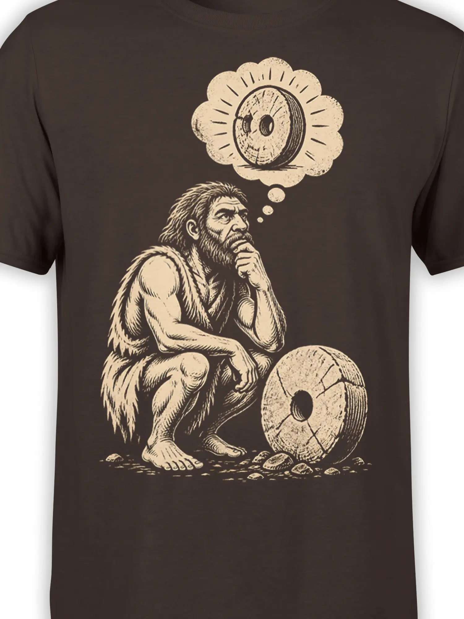 Close-up of thoughtful caveman and stone wheel artwork on a brown vintage graphic T-shirt