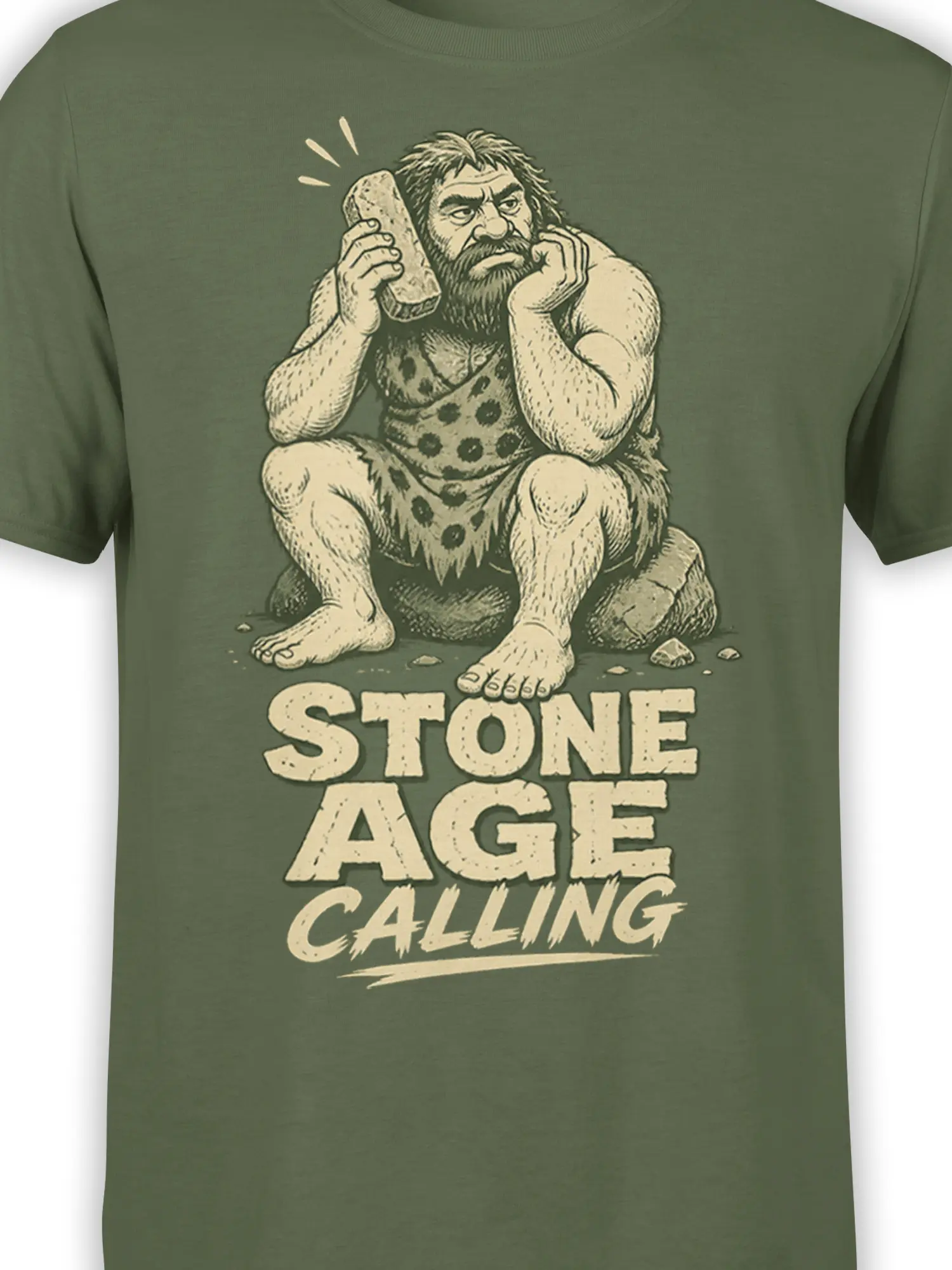 Close-up of the prehistoric caveman artwork and “STONE AGE CALLING” text on a green shirt