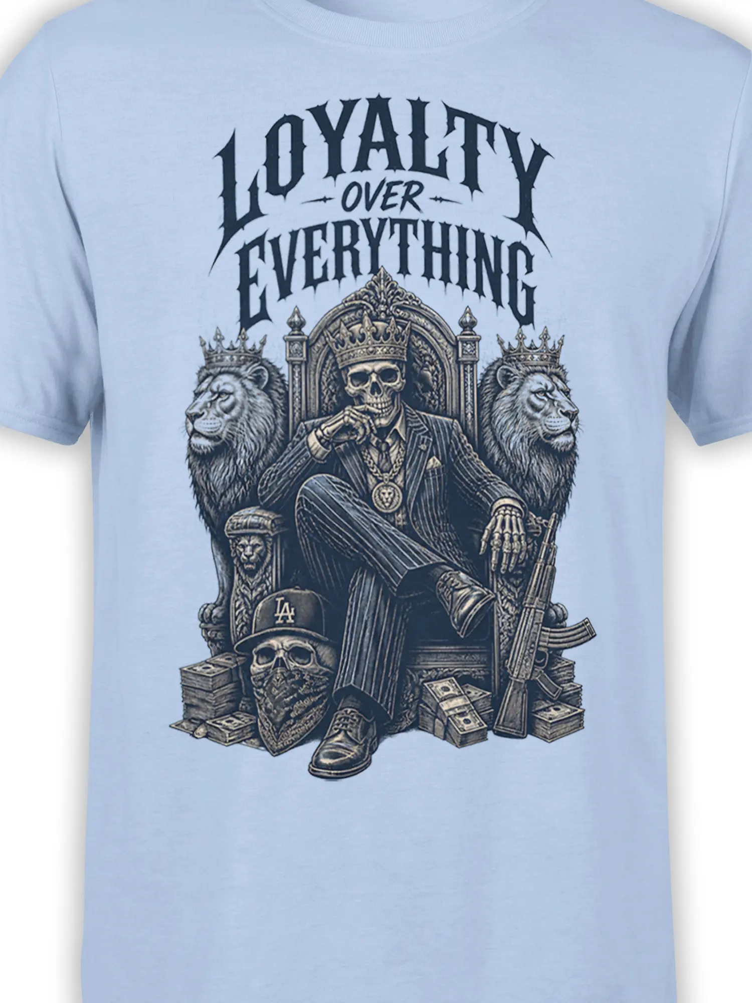 Close-up of crowned skull king design with lions, throne details, money stacks, and loyalty slogan on light blue fabric