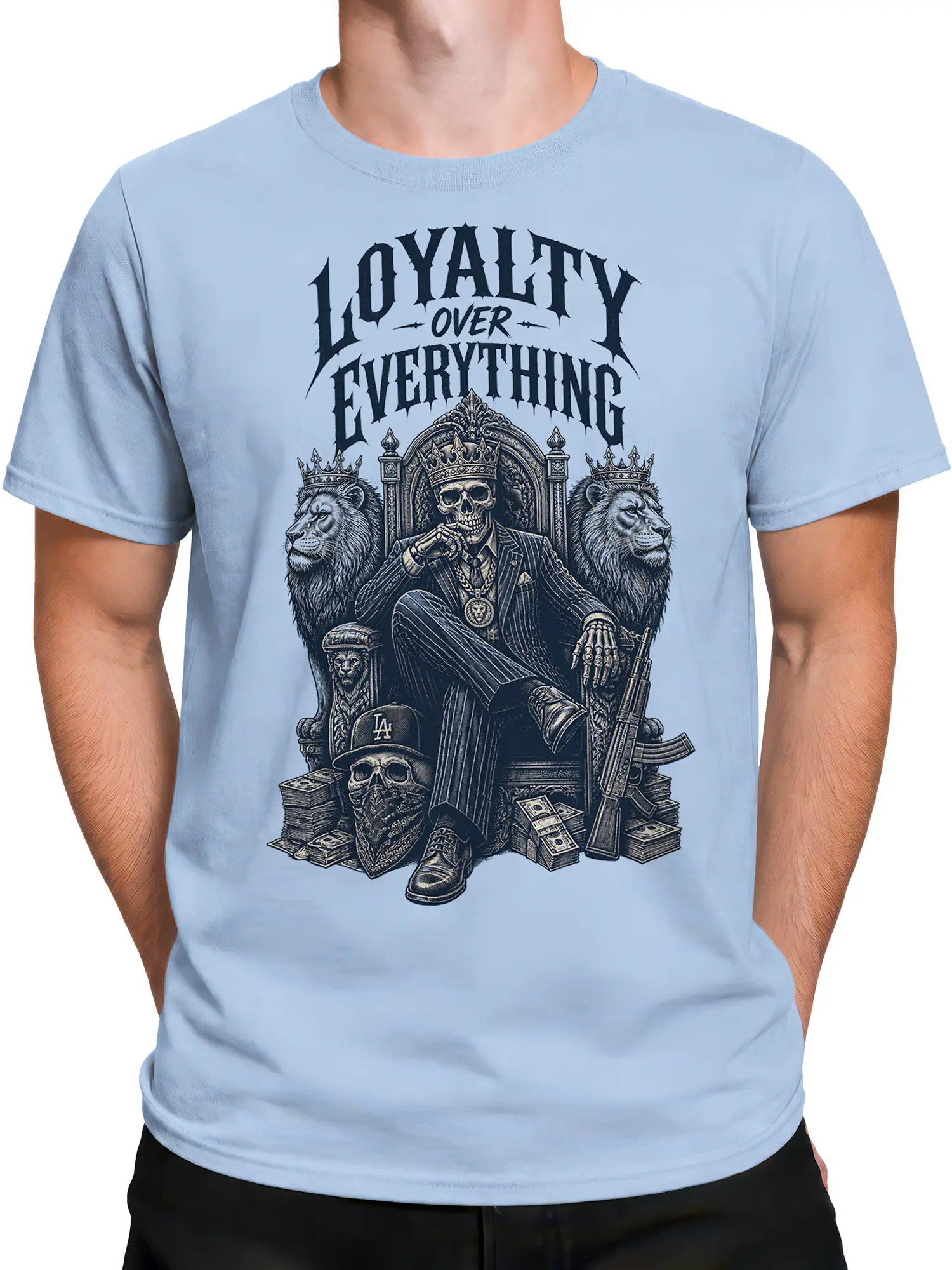 Male torso wearing a light blue crowned skull T-shirt with lions, throne artwork, and “LOYALTY OVER EVERYTHING” text