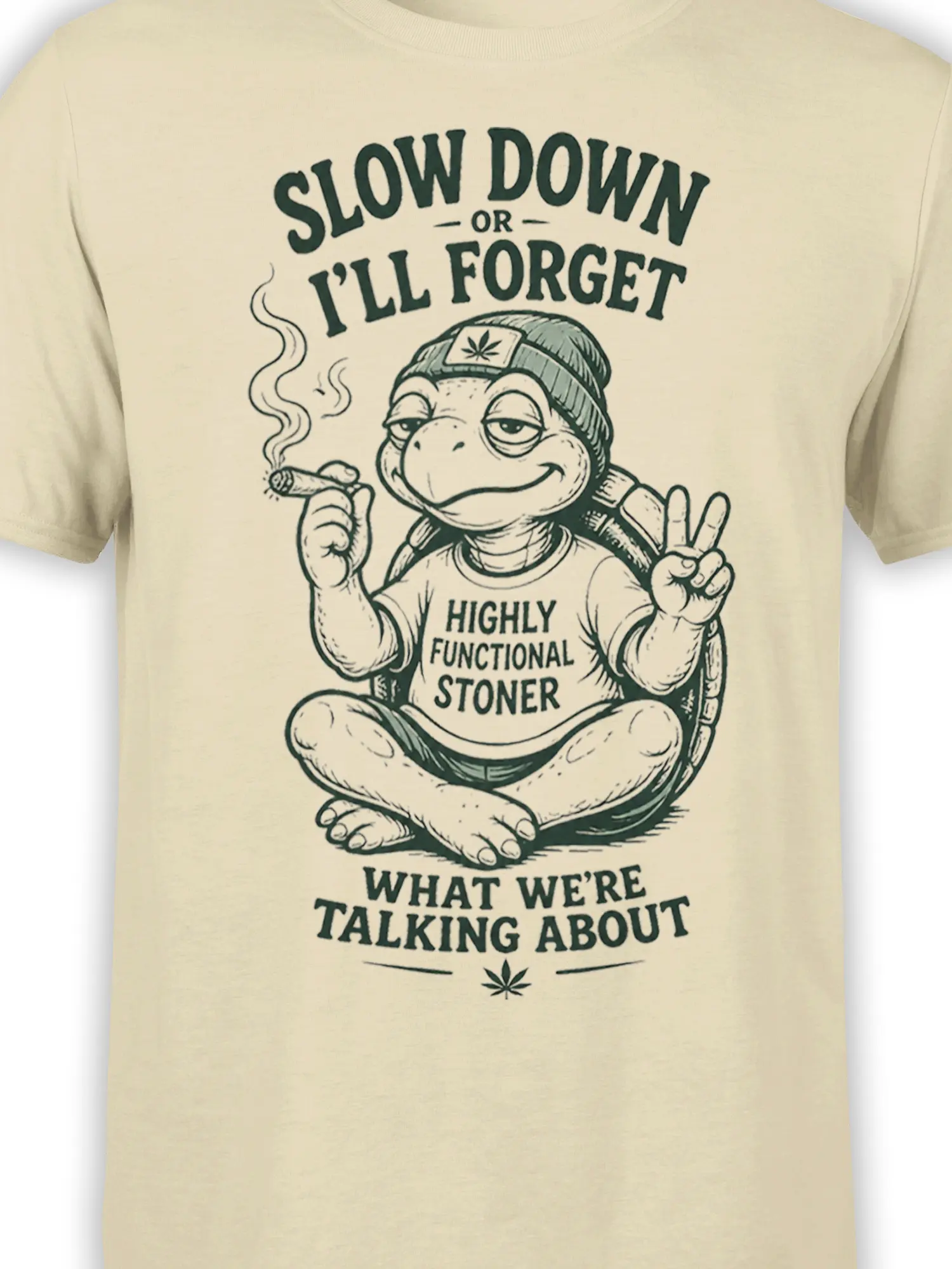 Close-up of the mellow turtle graphic, beanie, smoking roll, peace sign, and lettering on a cream shirt