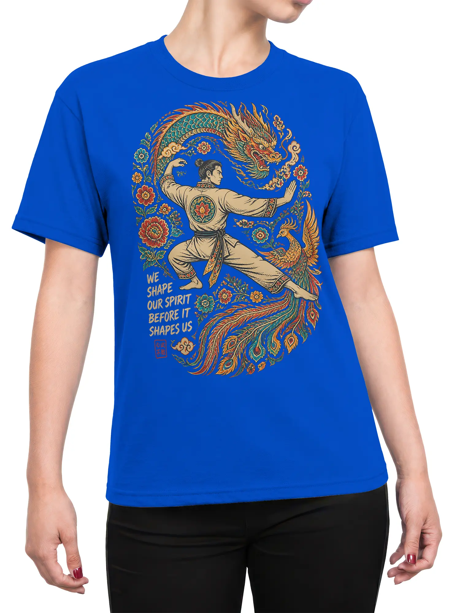 Female torso wearing a blue T-shirt with martial artist, dragon, phoenix, floral art, and spirit quote