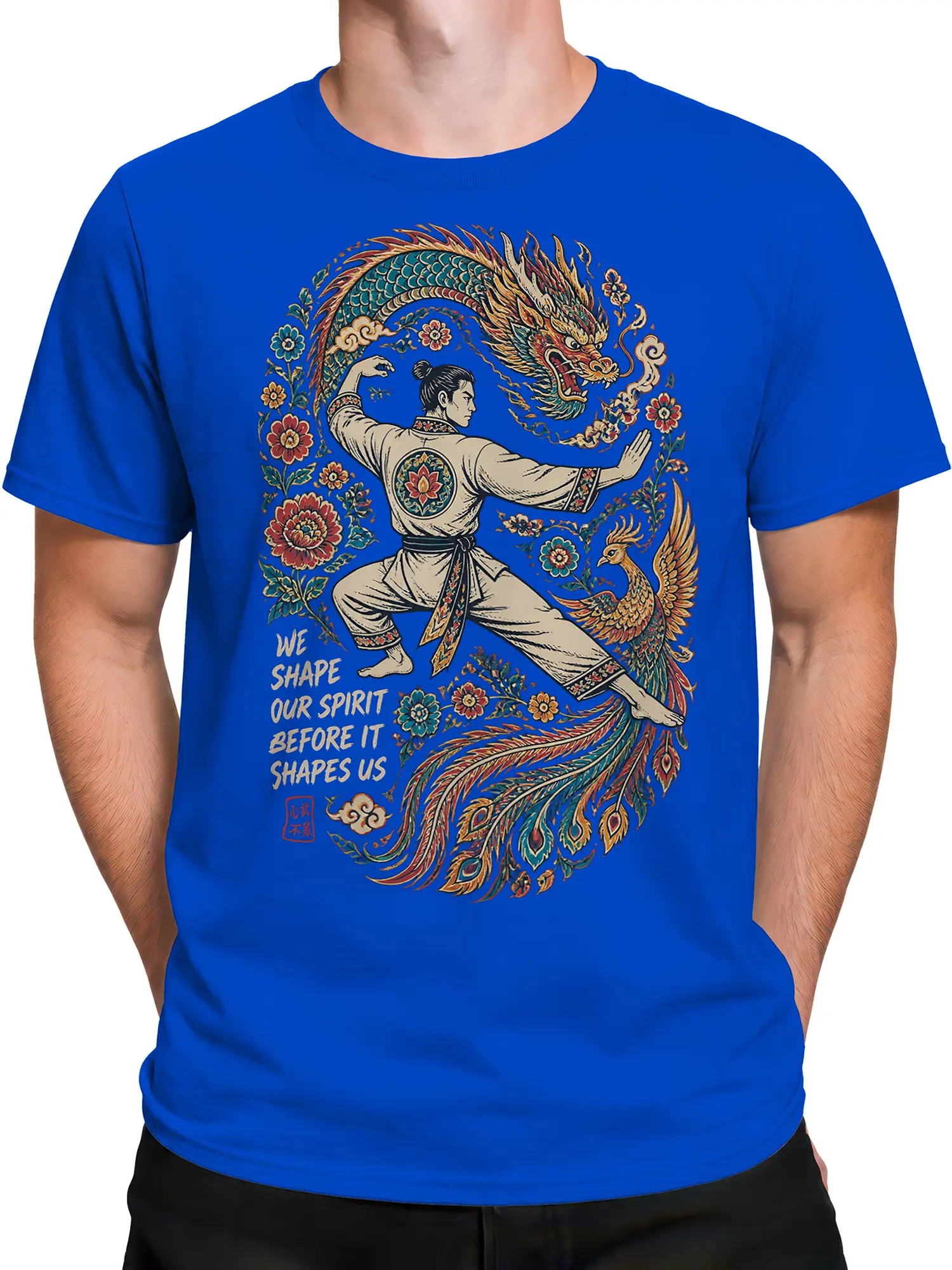 Male torso wearing a blue T-shirt with dragon, phoenix, martial artist, and colorful floral artwork