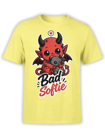 Yellow T-shirt with a cute red devil hugging a stitched bat plush and “Bad Softie” lettering