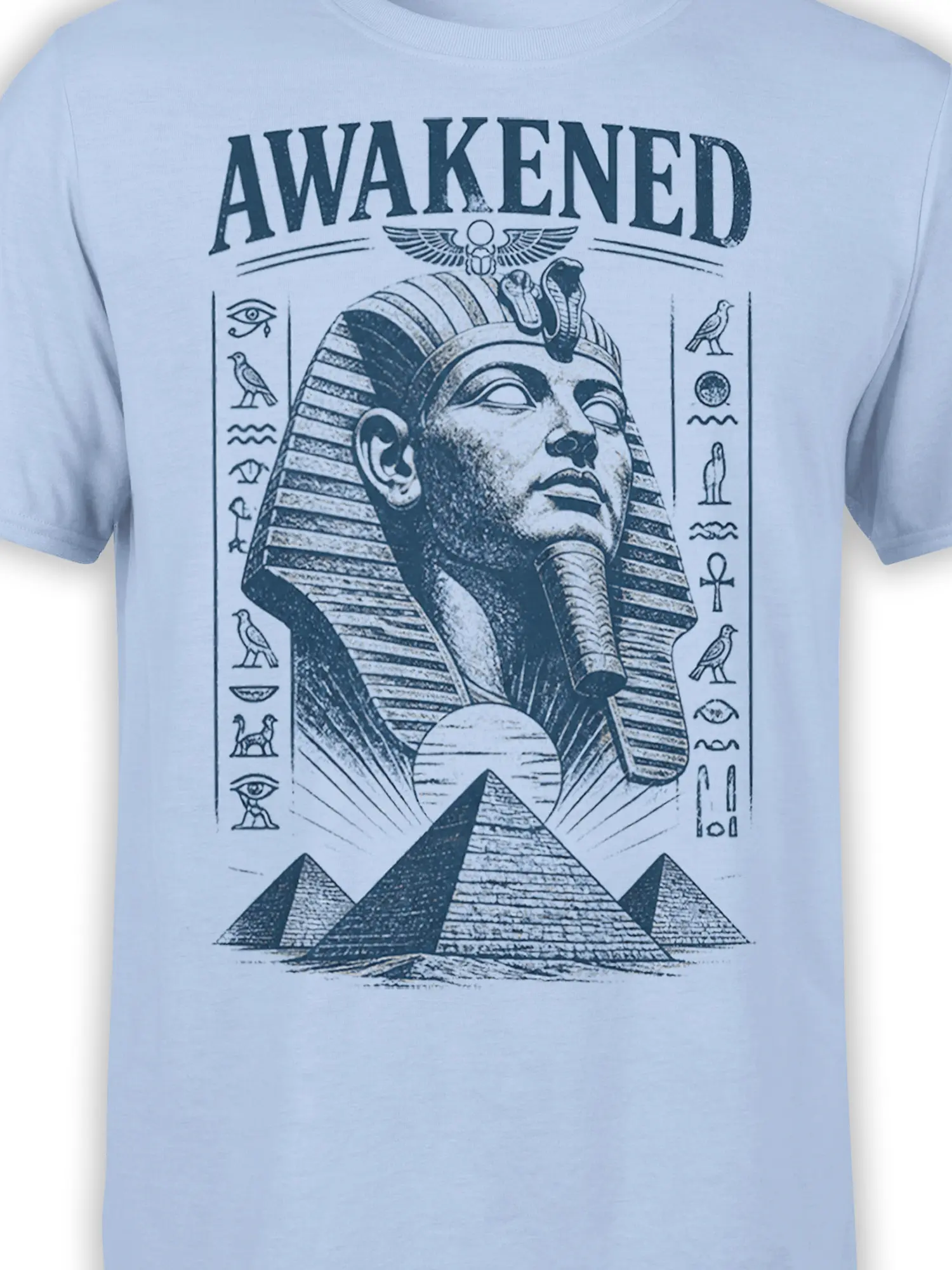 Close-up of awakened pharaoh artwork with pyramids and Egyptian symbols on a light blue T-shirt