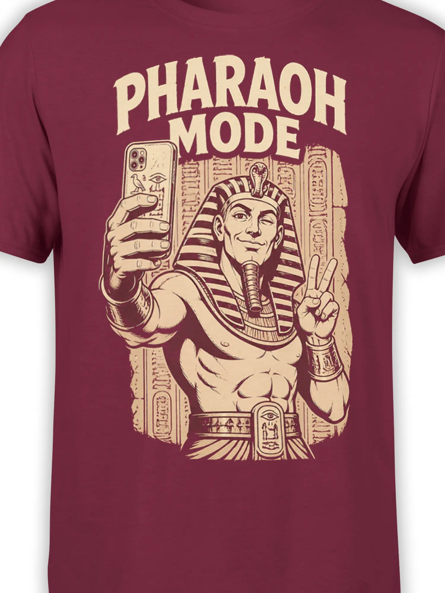 Close-up of pharaoh selfie artwork and hieroglyphic details on a burgundy Egyptian graphic T-shirt