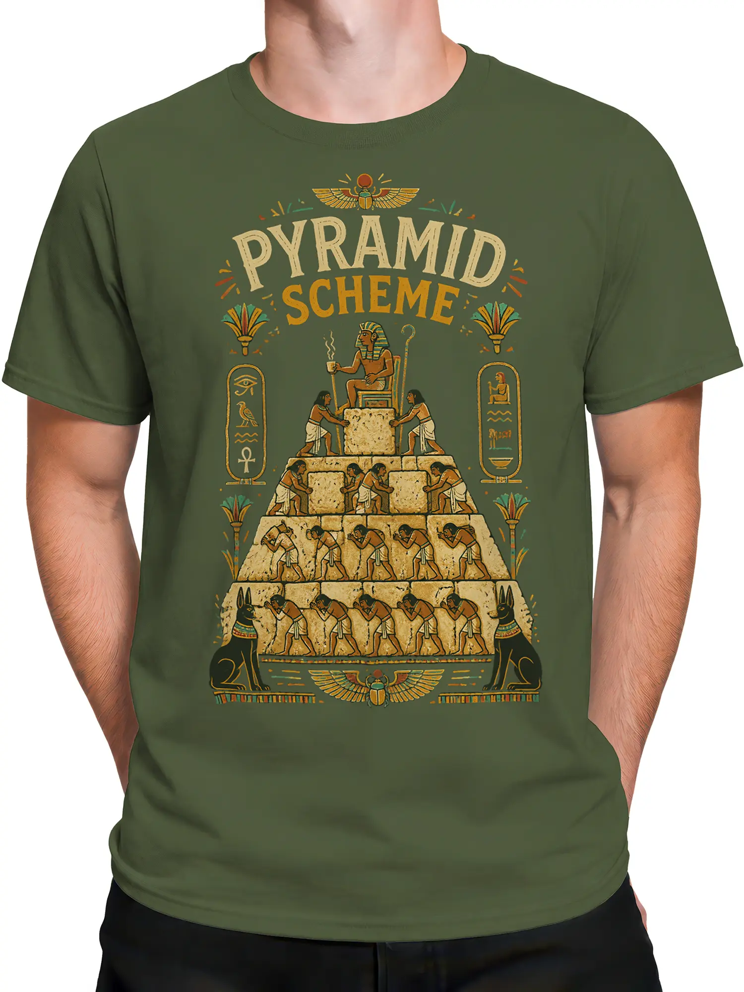 Male torso wearing a green Egyptian Pyramid Scheme T-shirt with pyramid builders and Anubis artwork