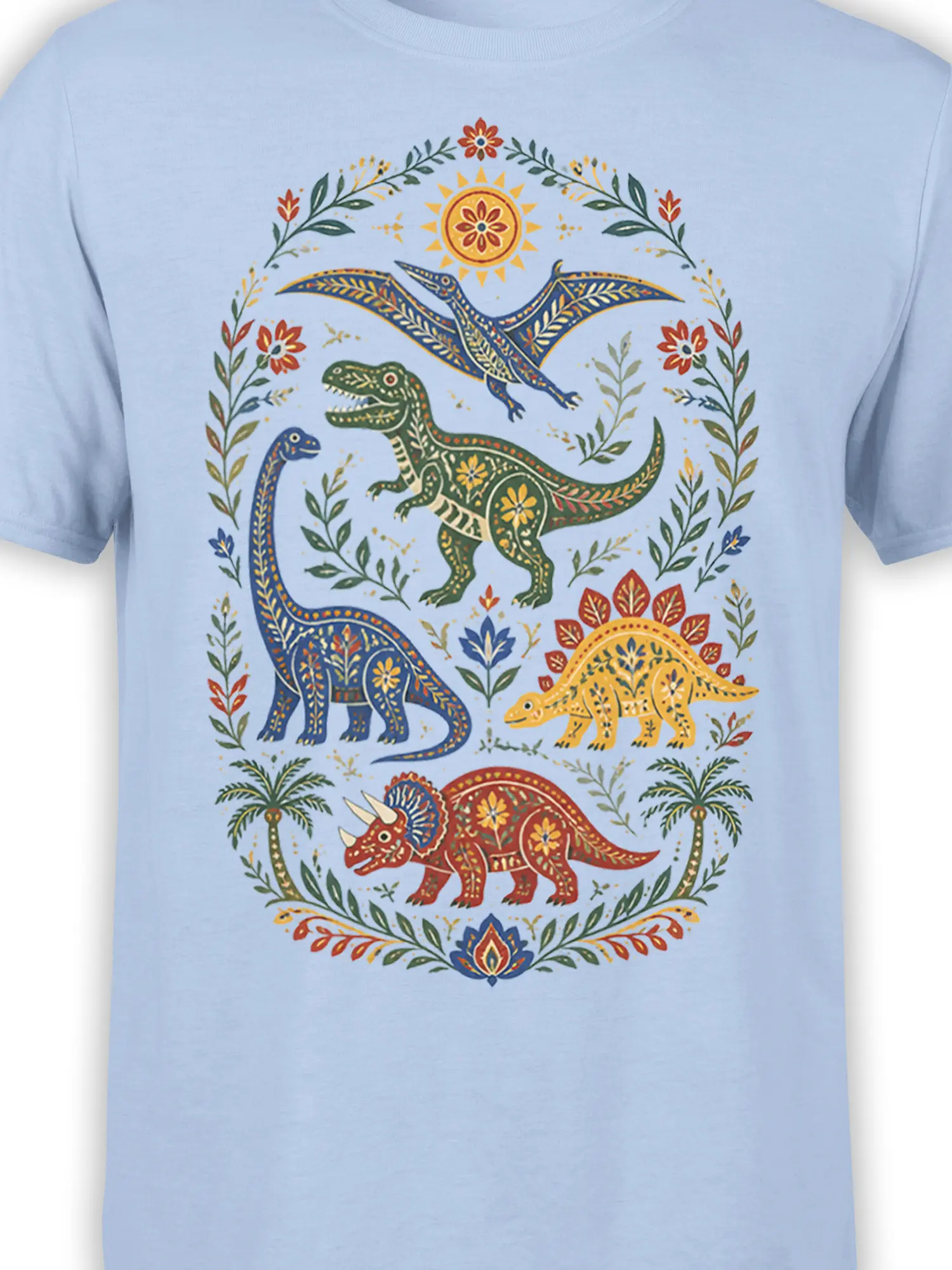 Close-up of colorful dinosaur illustrations, floral details, and botanical patterns on a light blue shirt